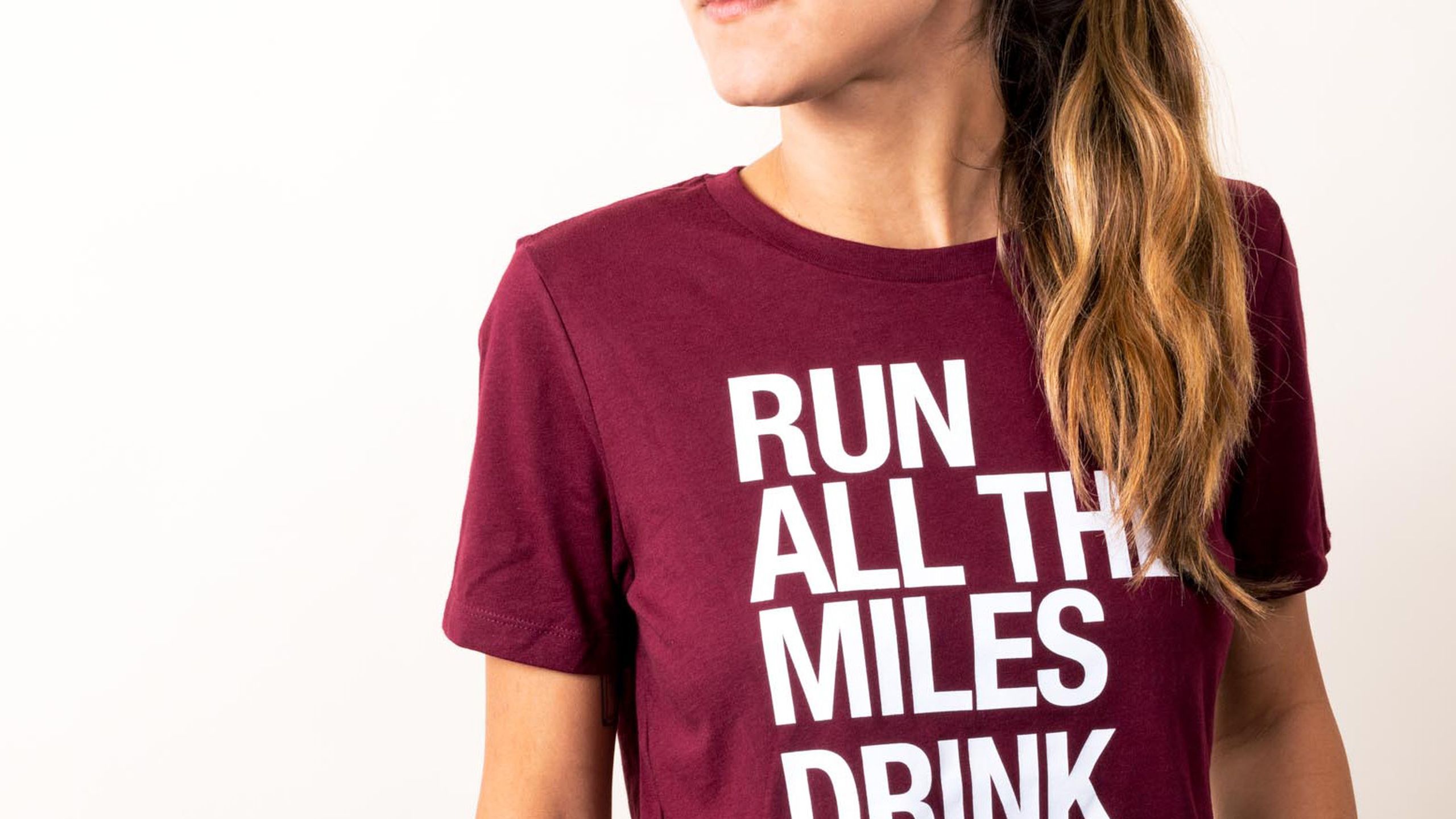 close up of a women wearing a maroon t-shirt