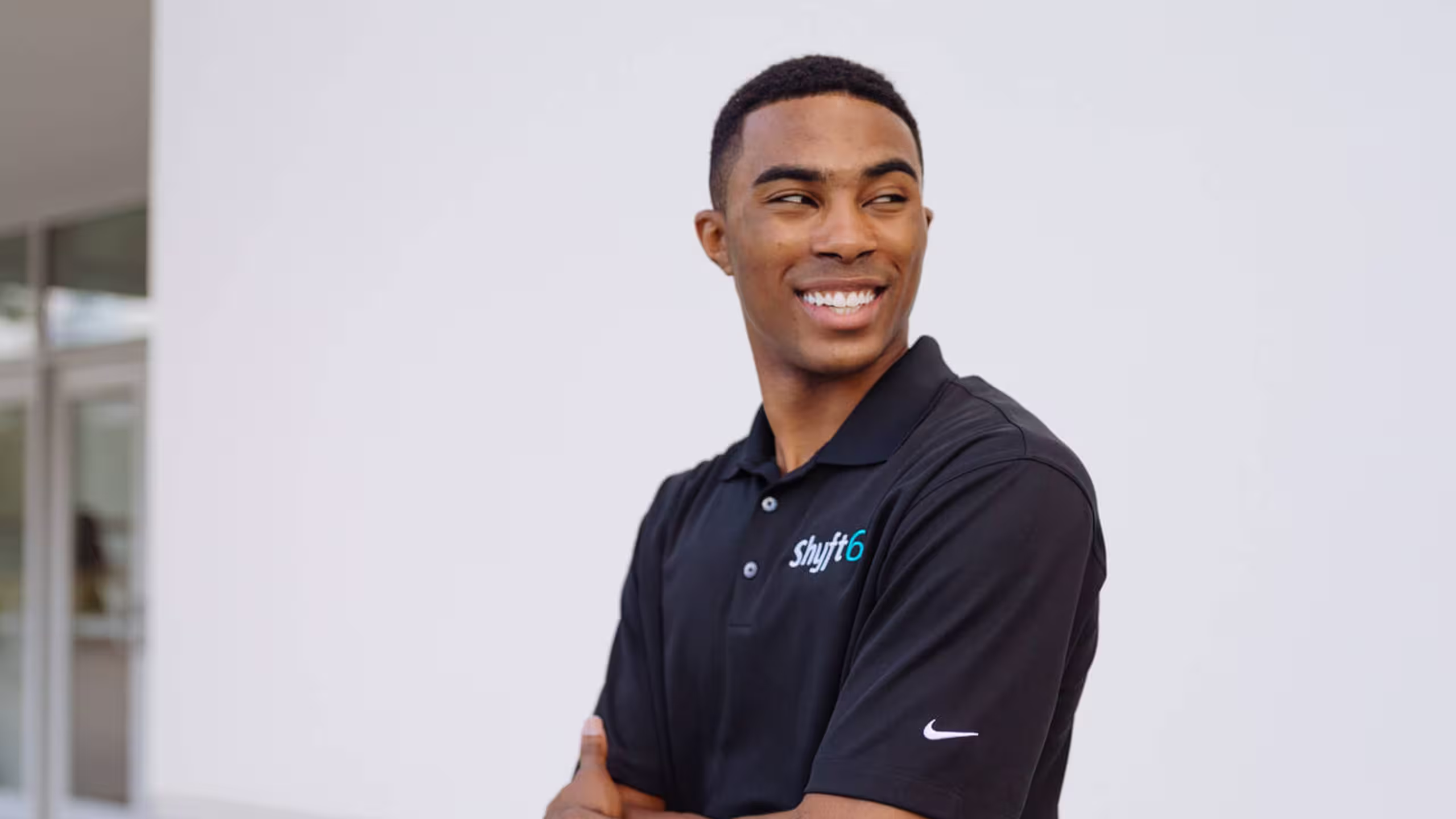 man wearing a black nike polo with a embroidered logo on the front top right