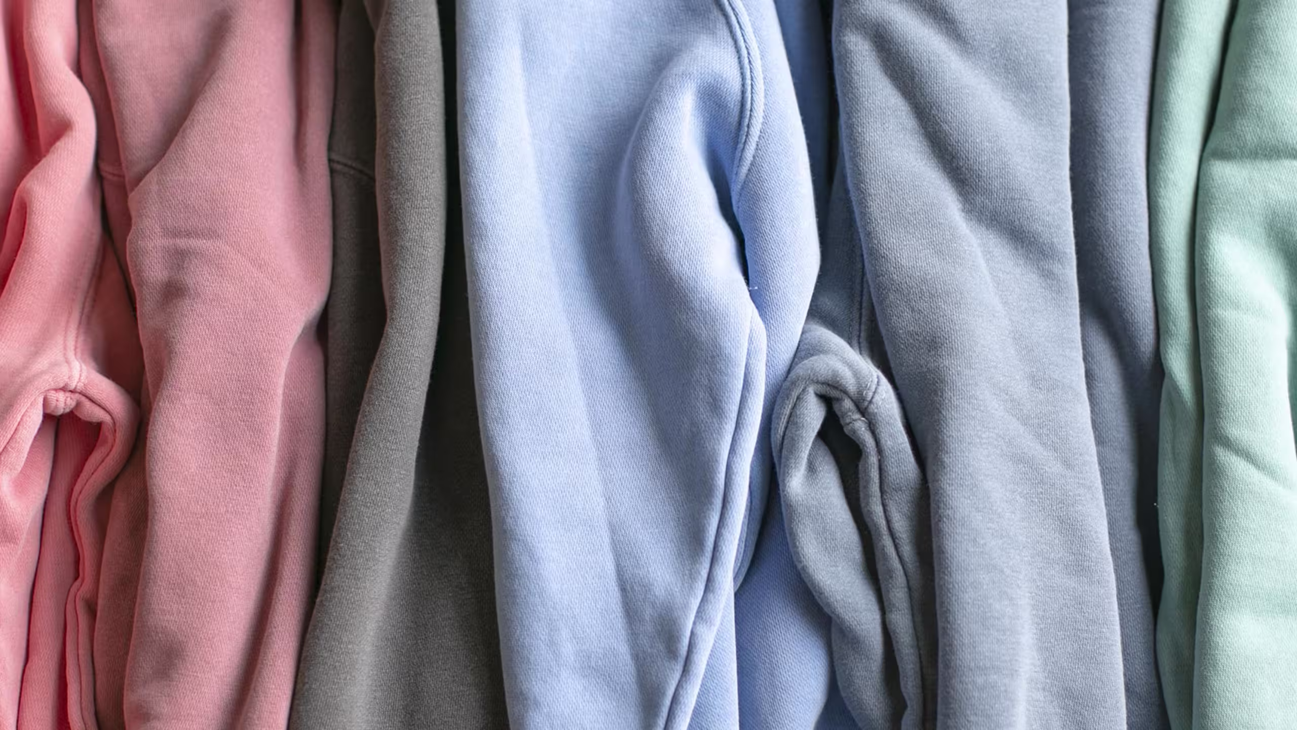 close up of pastel color sweatshirts press together