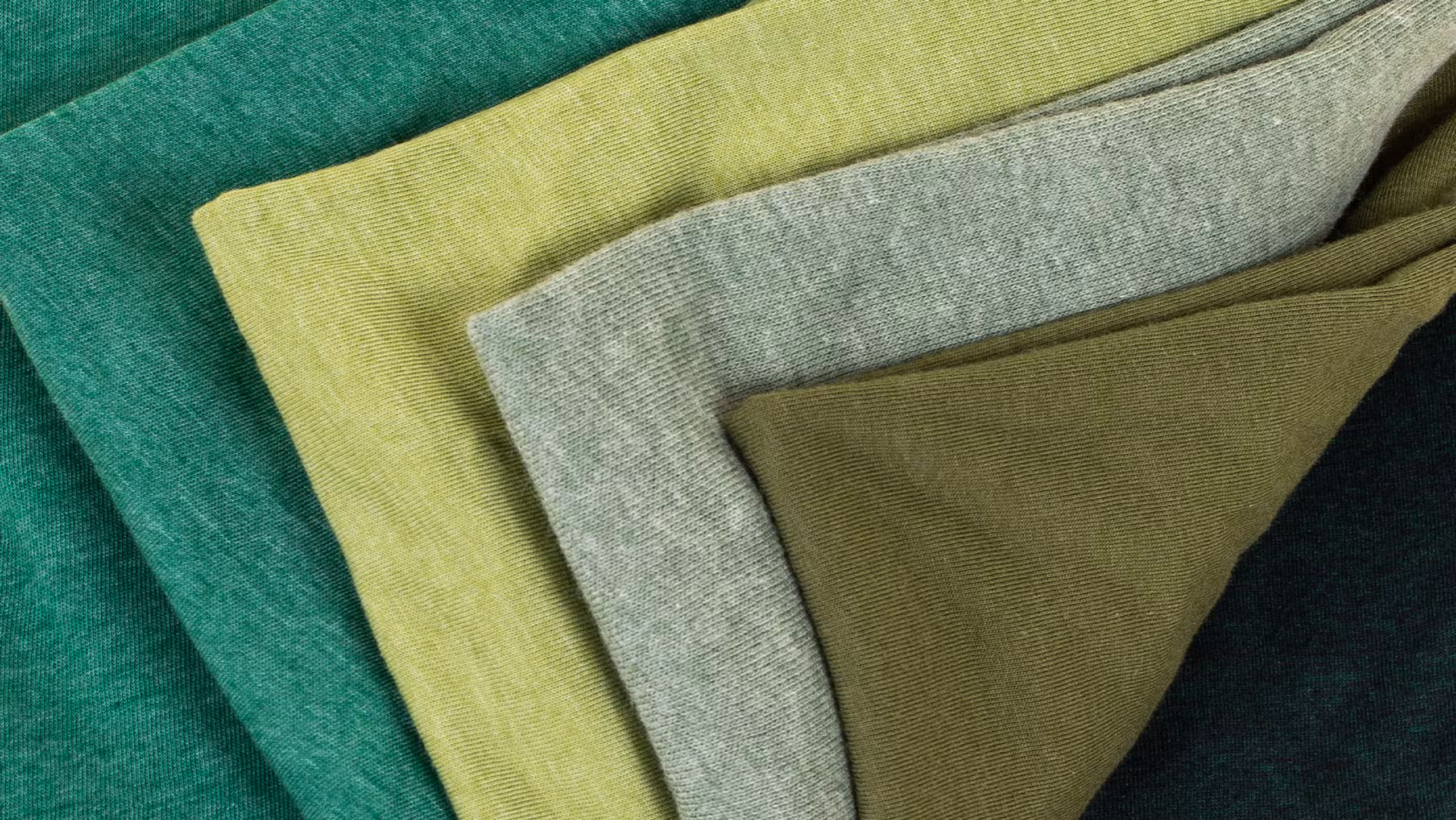 green shirts stacked on themselves