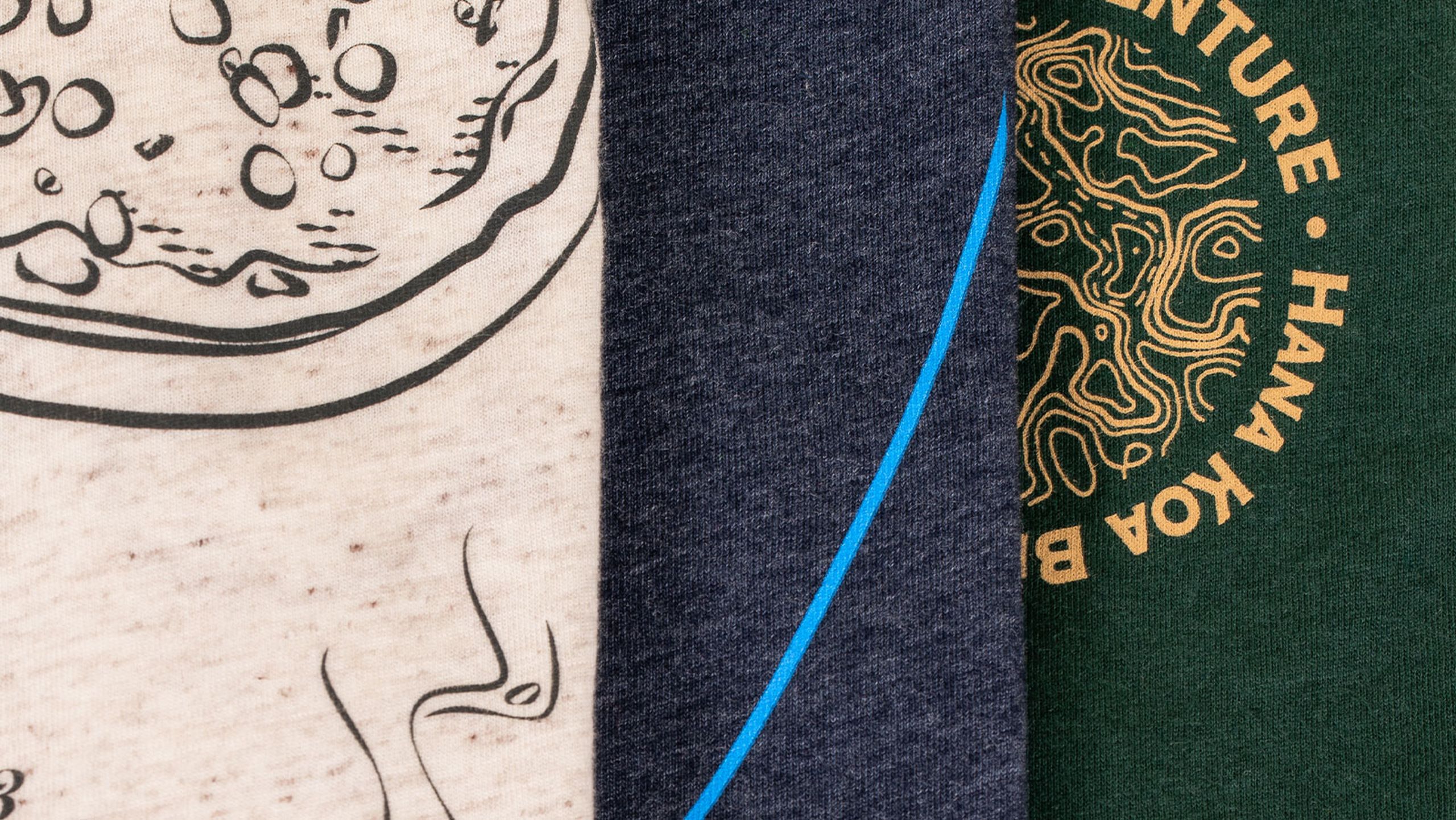 Close-up of three shirts. Left oat white, middle navy, and right dark green.