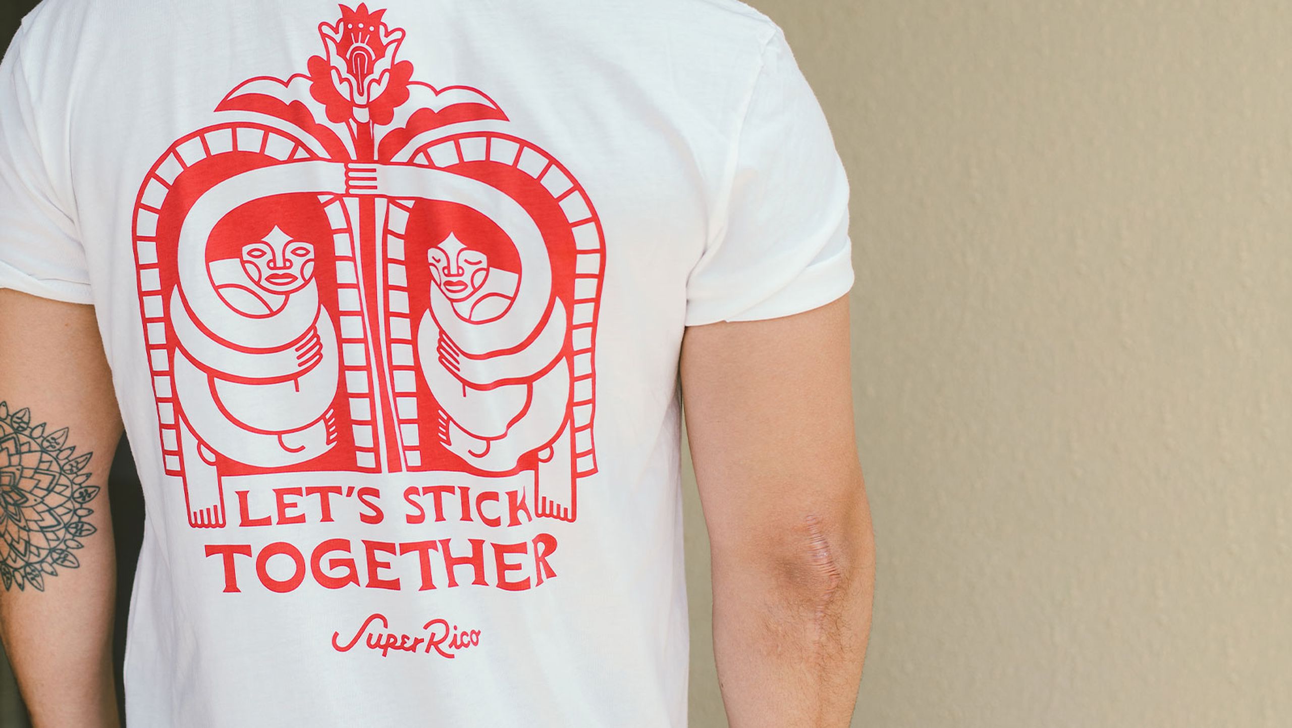 back of a man wearing a white shirt with red imprint design