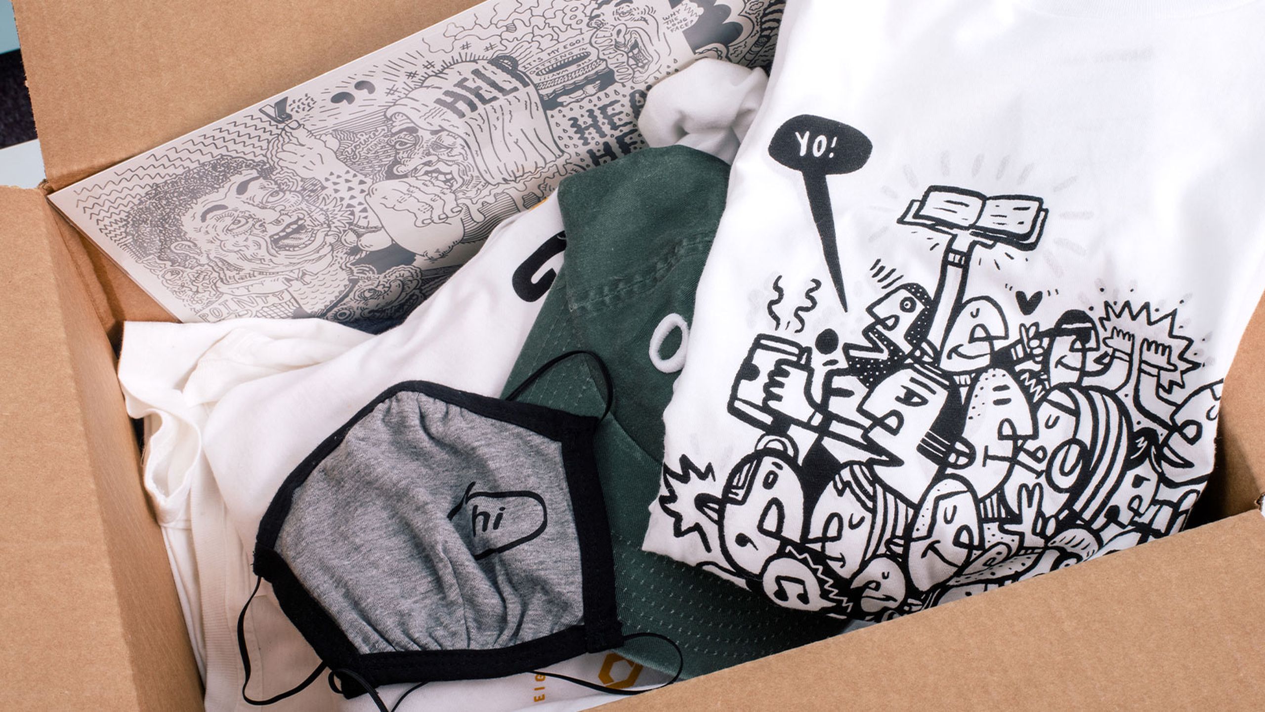 box of t-shirts, hats, and other things