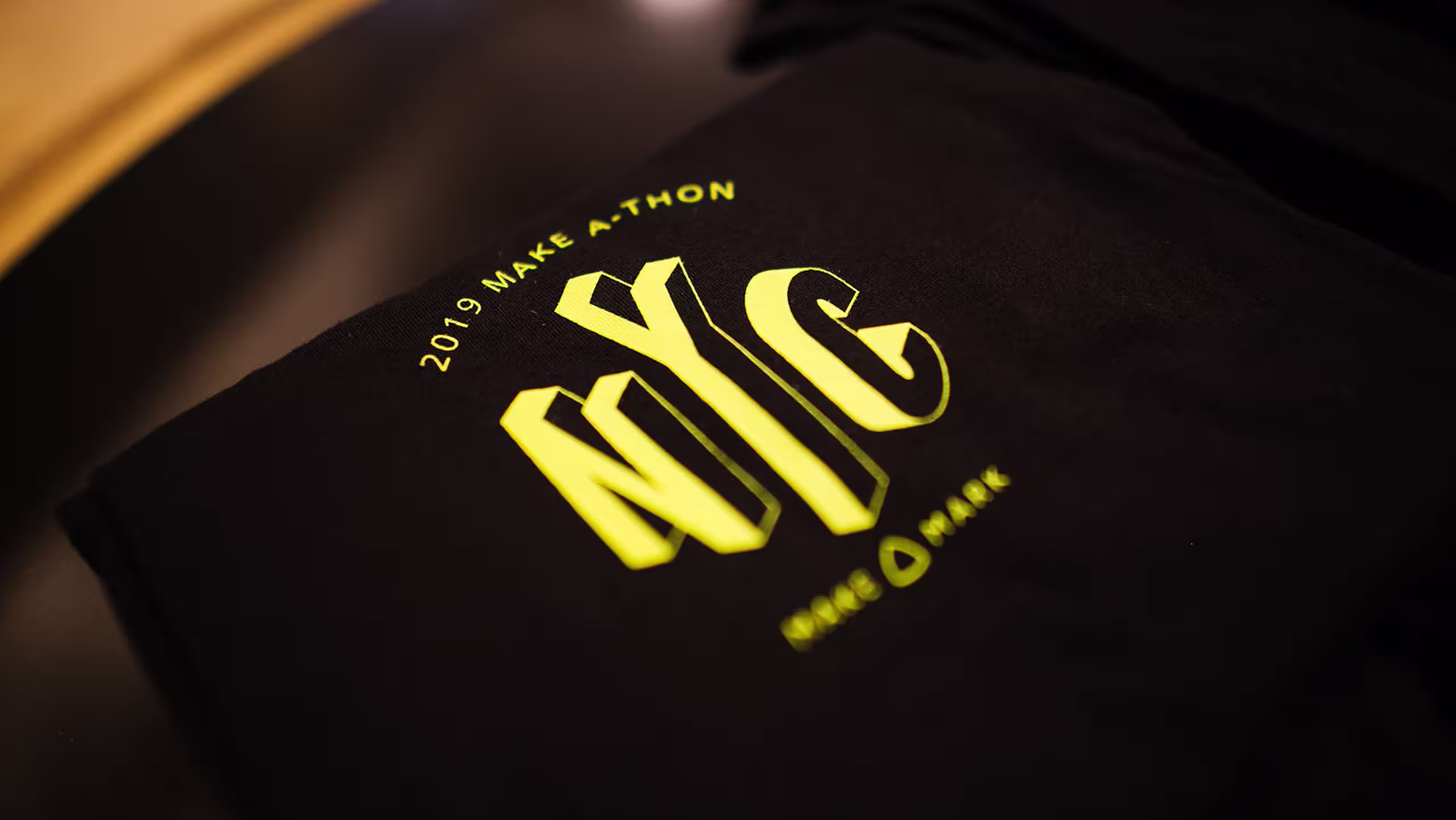 close up of 2019 make a thon NYC design on a black shirt