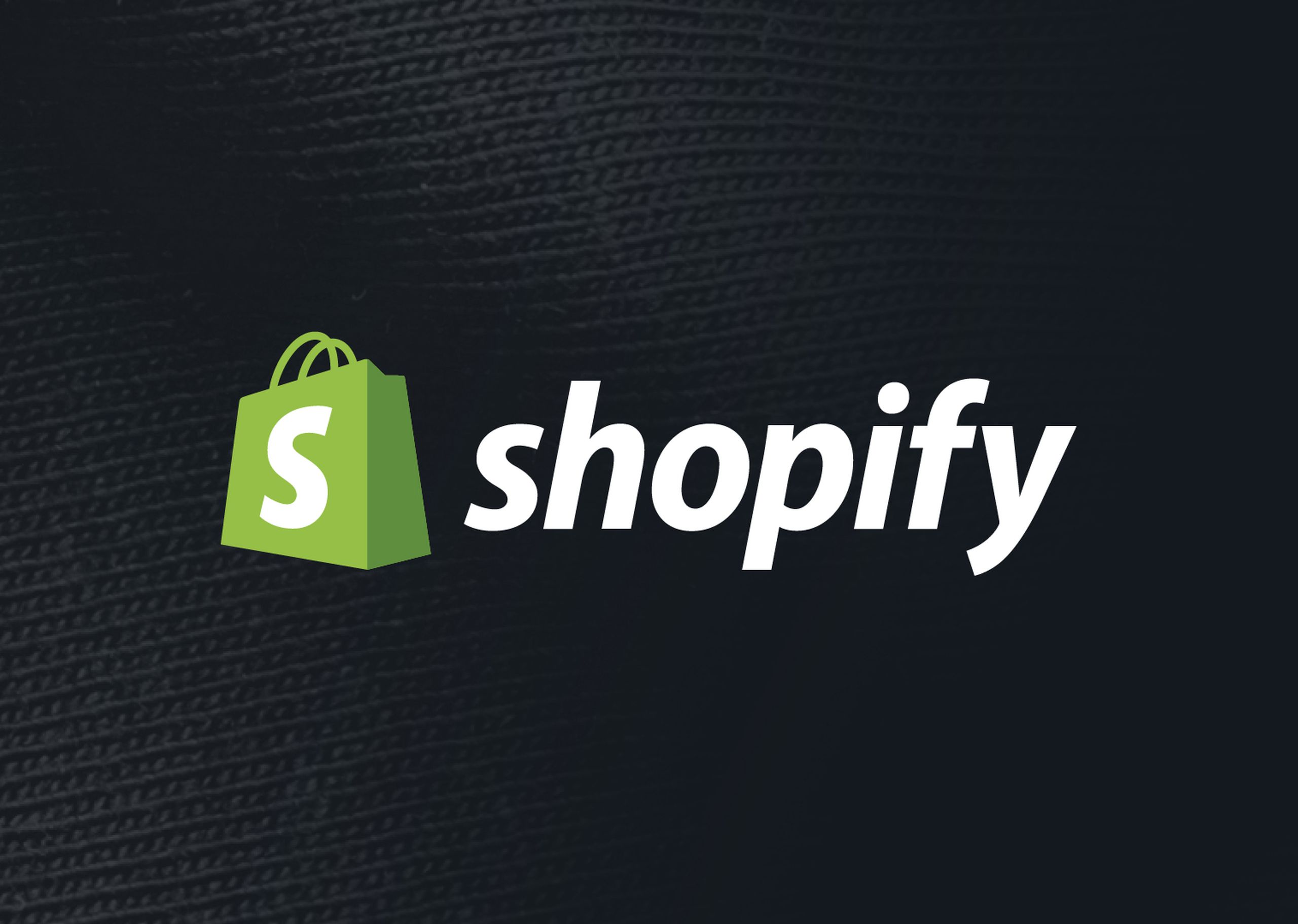 Shopify logo on a black fabric background
