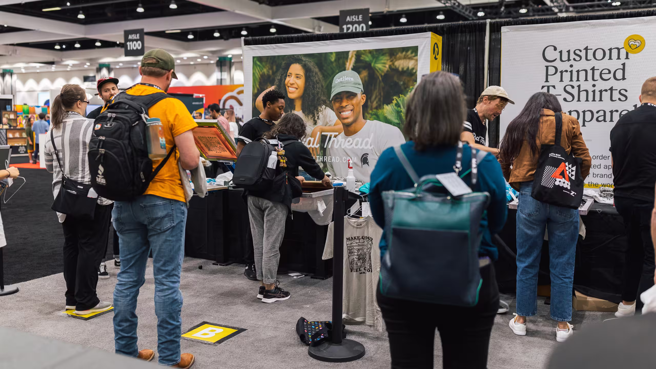 a bunch of people standing in a booth at a tradeshow