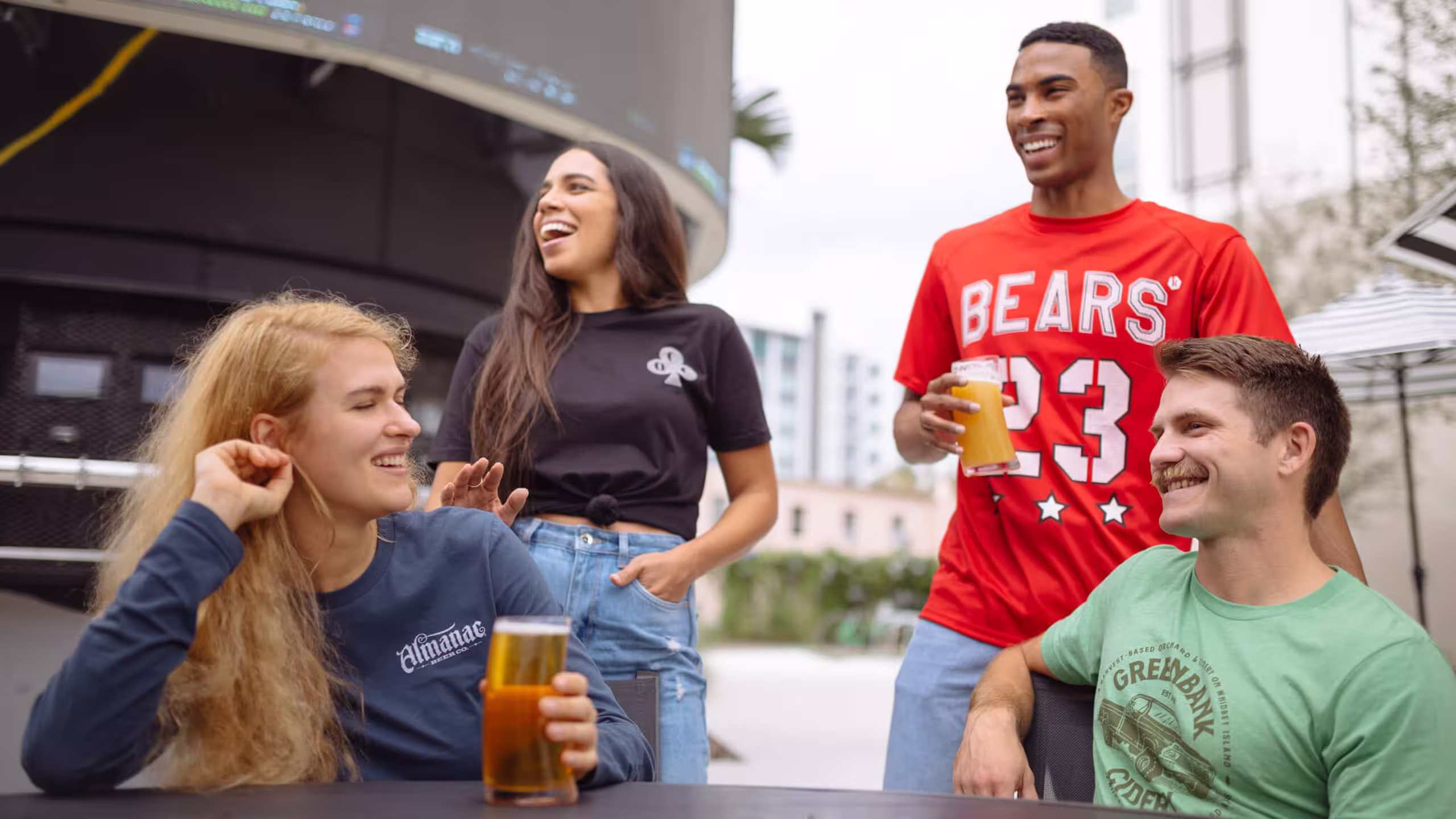 four people together drinking beer