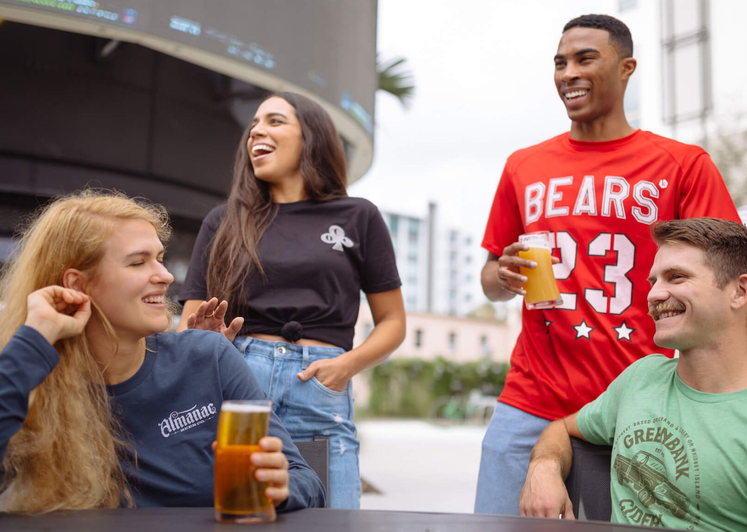 four people together drinking beer