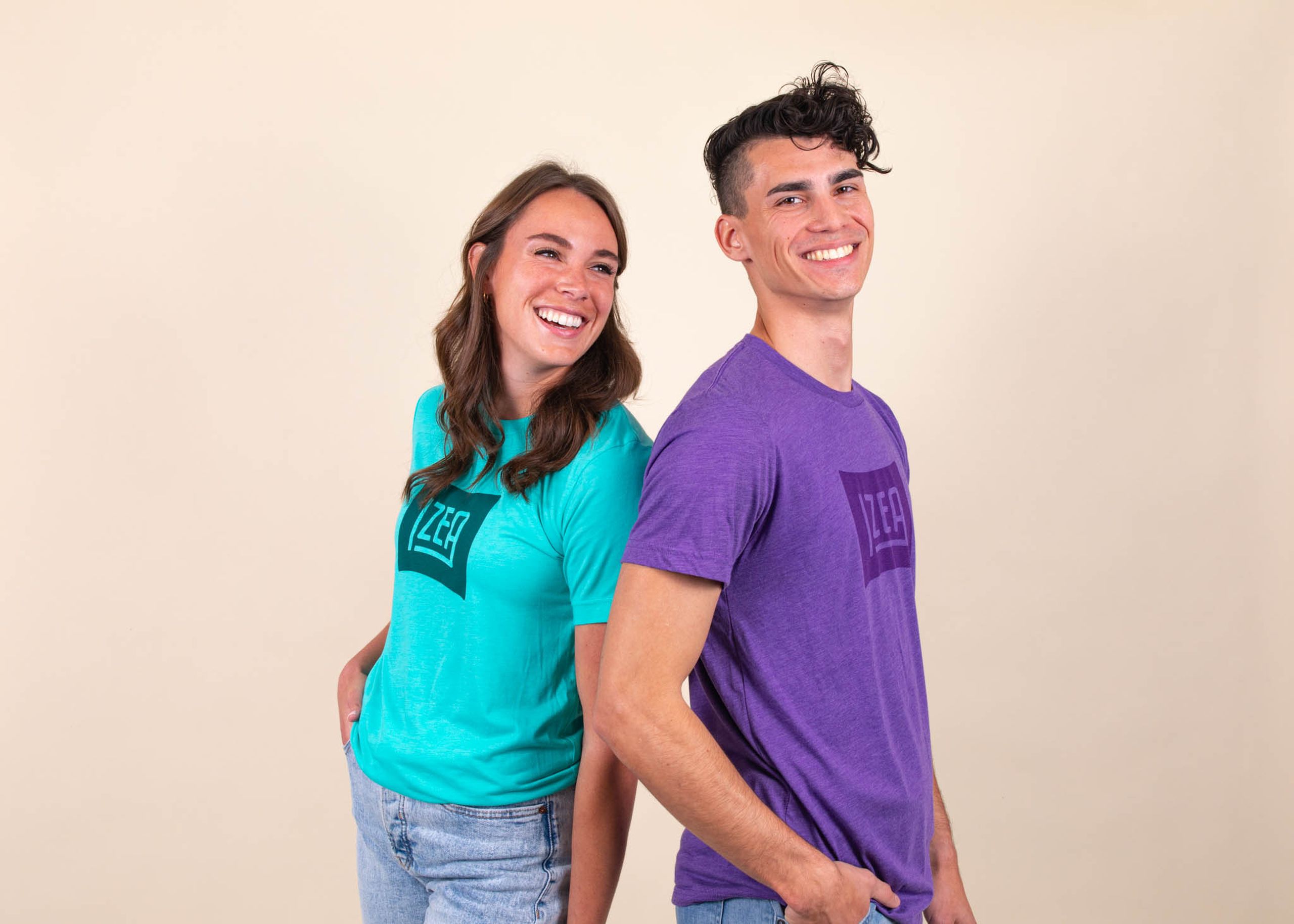 A woman and a man wear shirts in blue and purple, respectively, with a matching tonal design 
