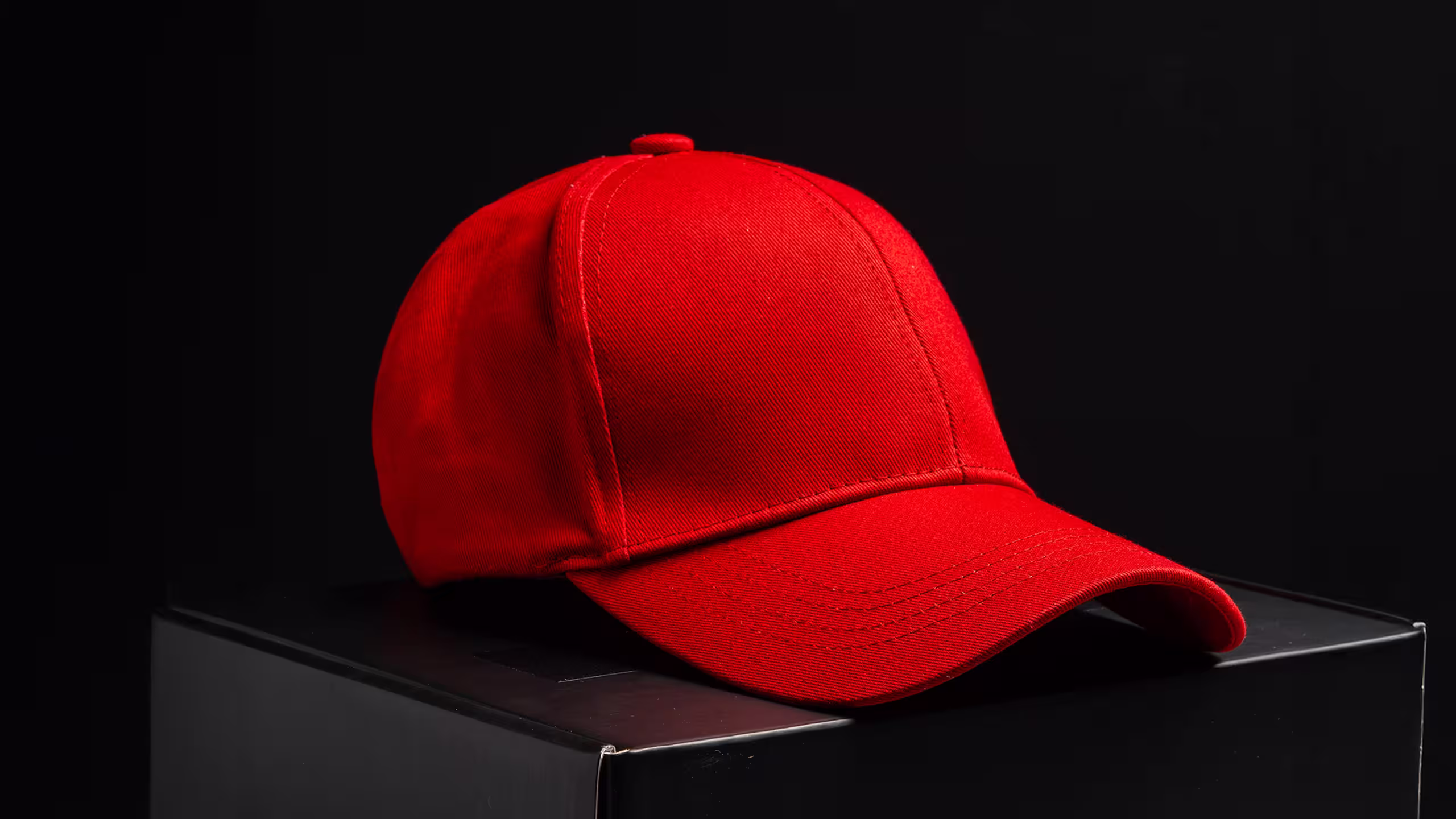 red dad hat on a black box