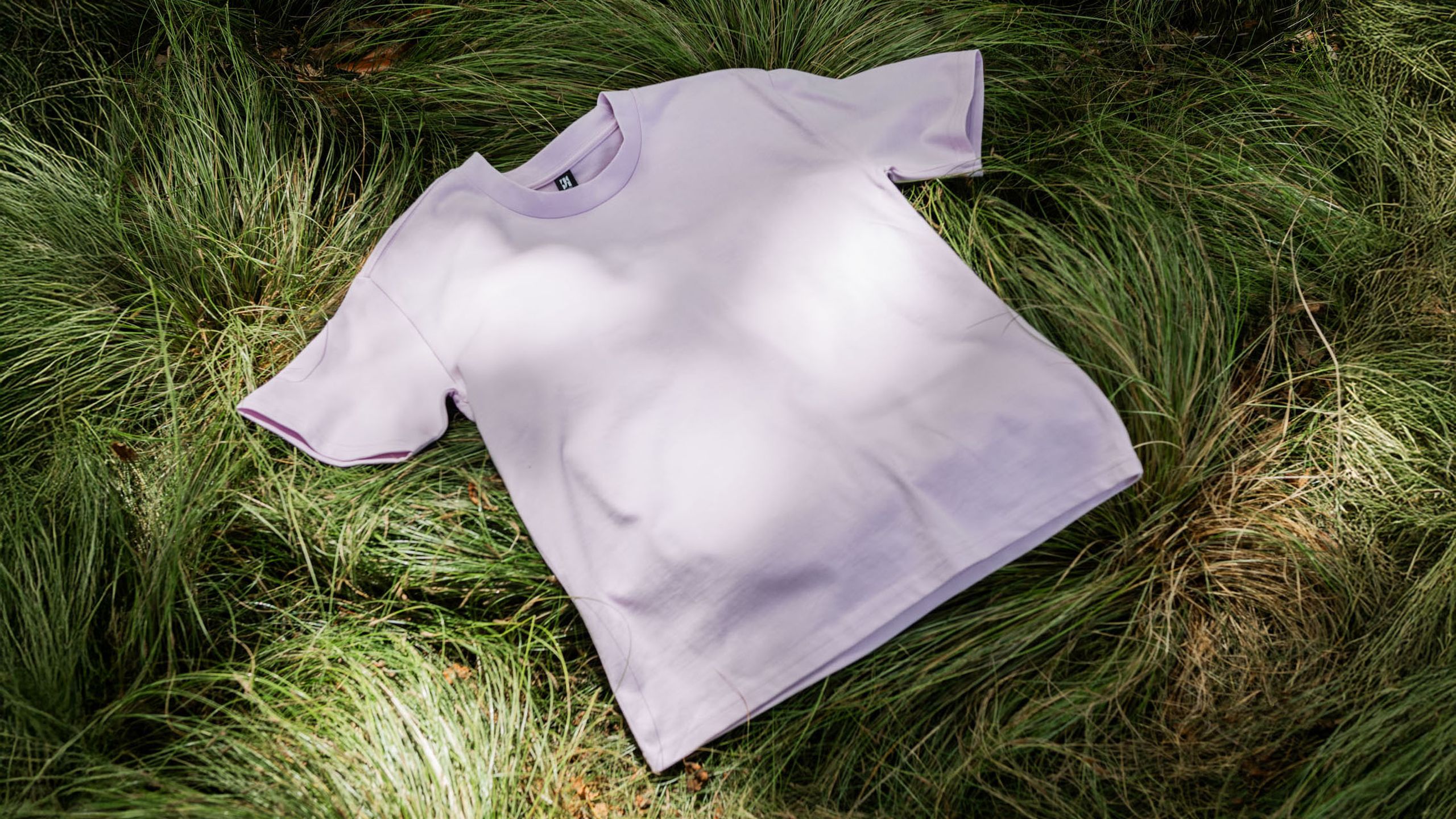 orchid color tee on grass