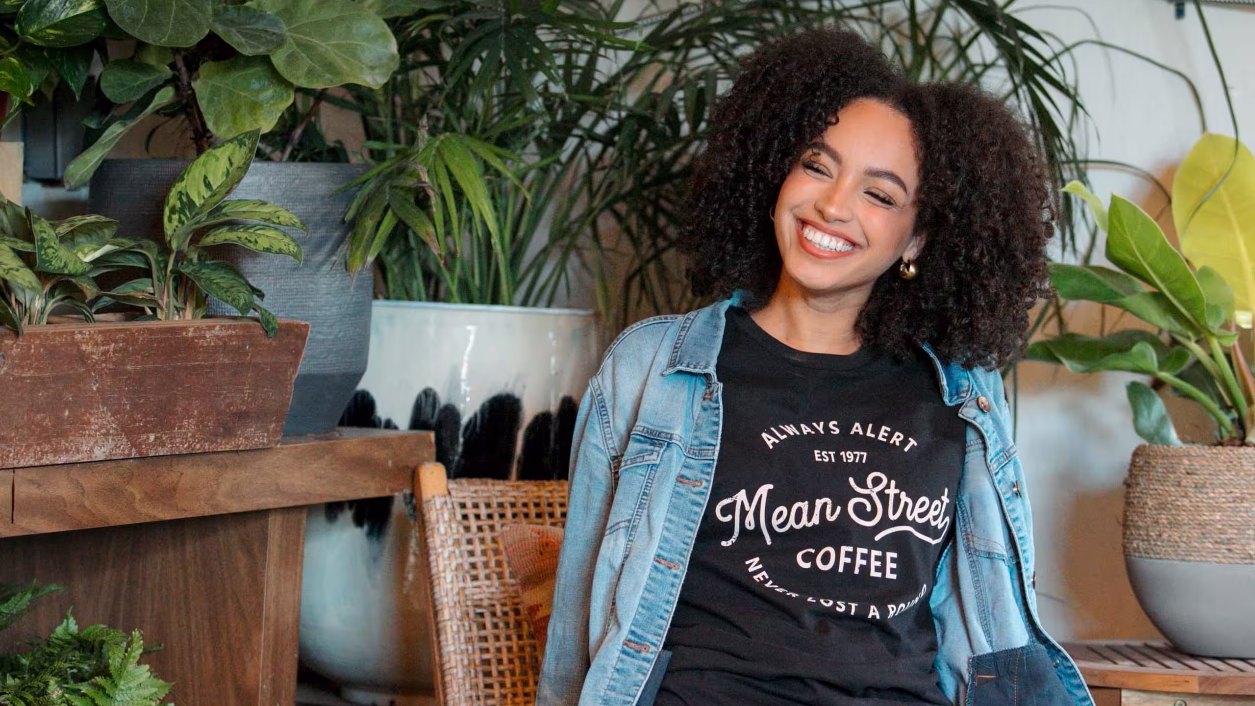 women wearing a black t-shirt with a jean jacket over it