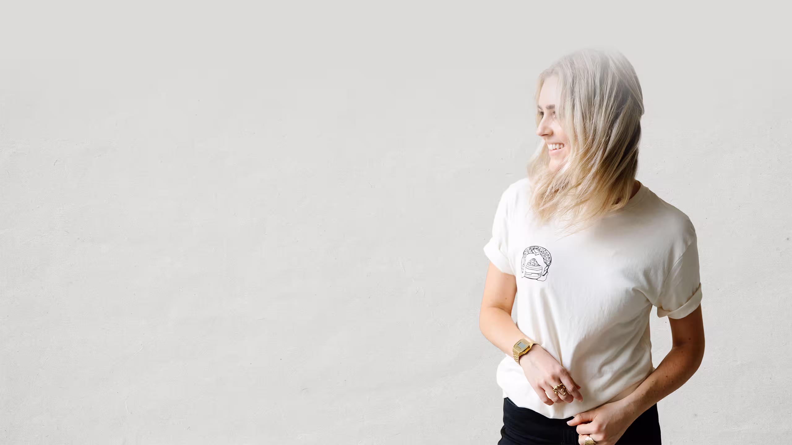 women wearing a bone color t-shirt with pancakes printing on the left pocket