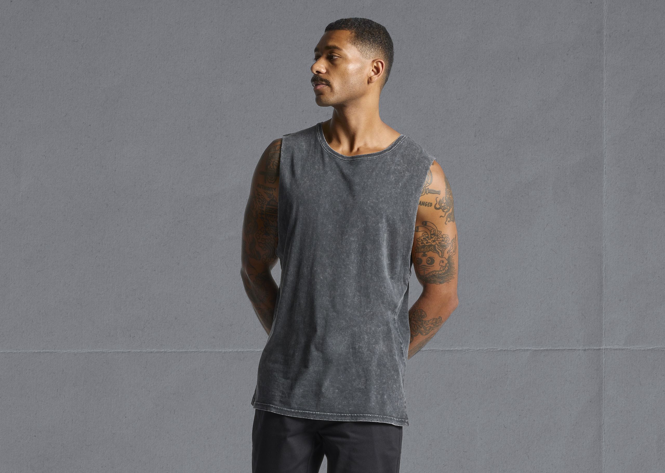 man wearing a black stone tank top