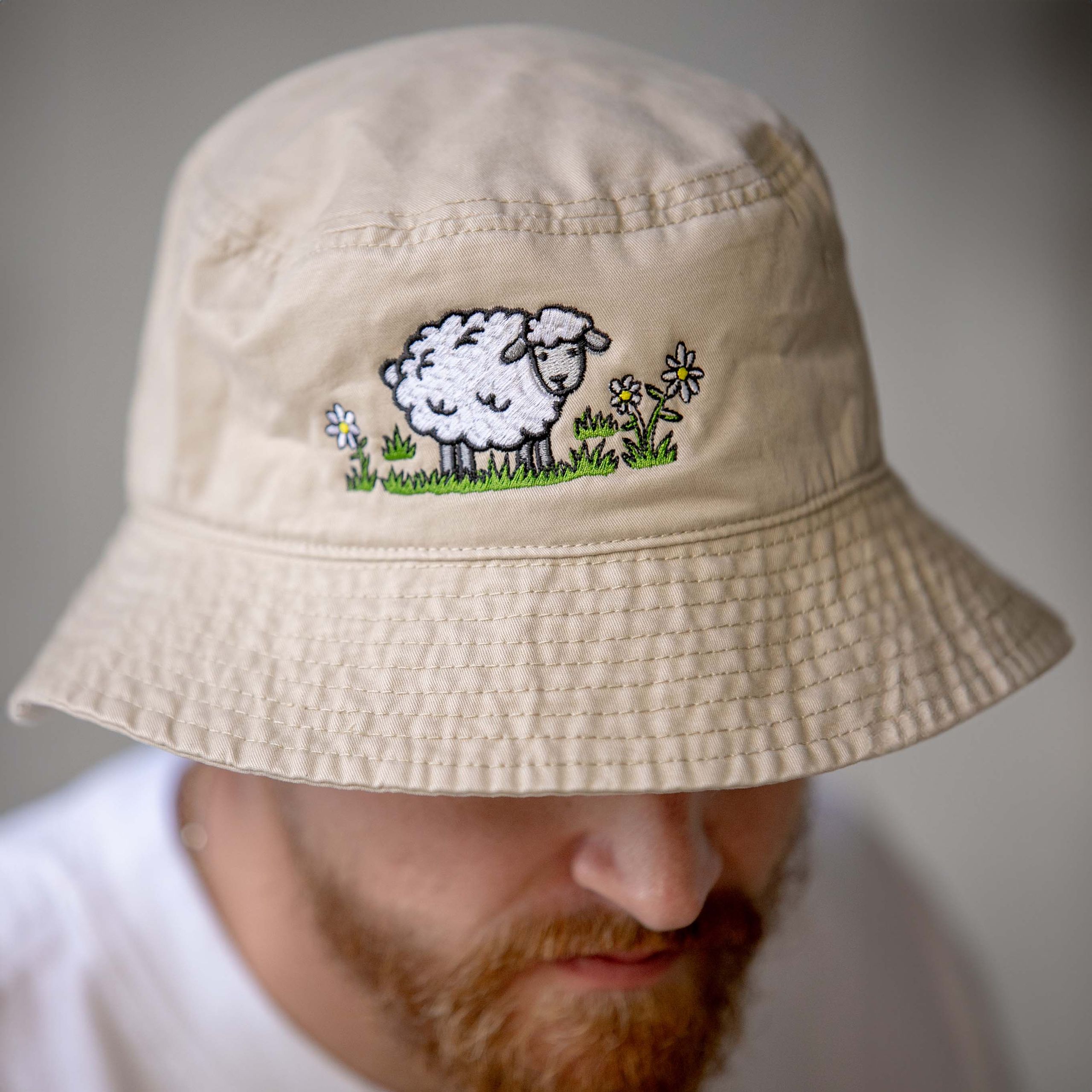 man wearing a light tan bucket hat