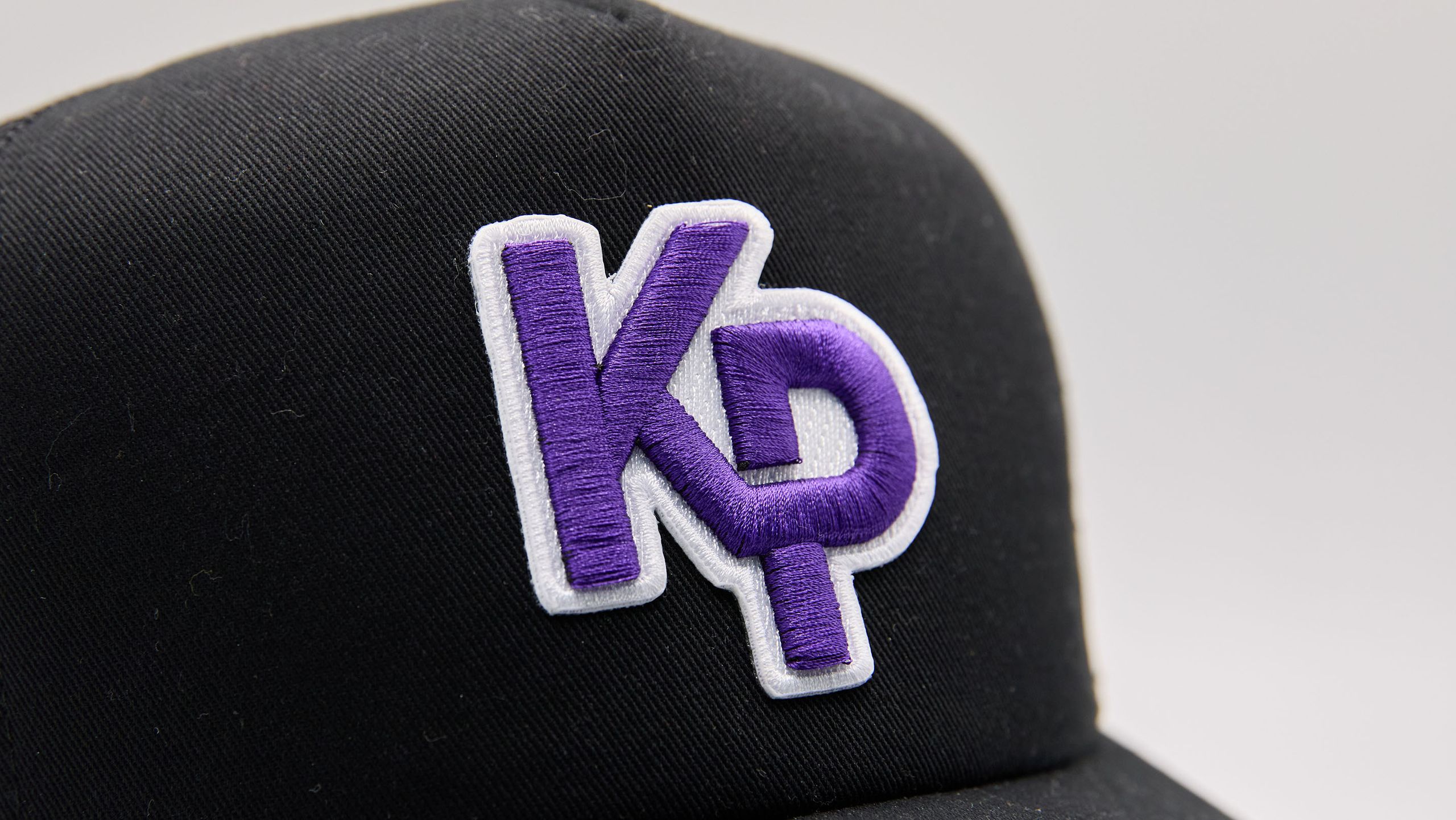 close up of a purple and white 3d embroidered patch
