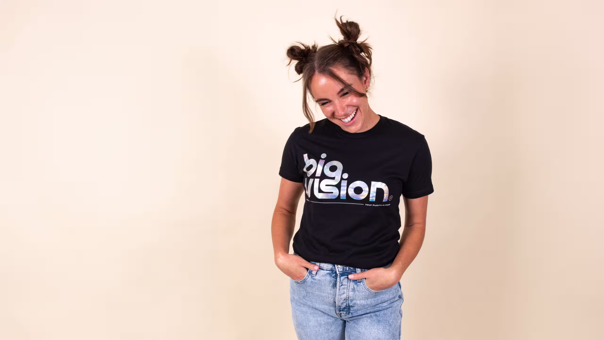 women wearing a black shirt with silver foil print of the words big vision