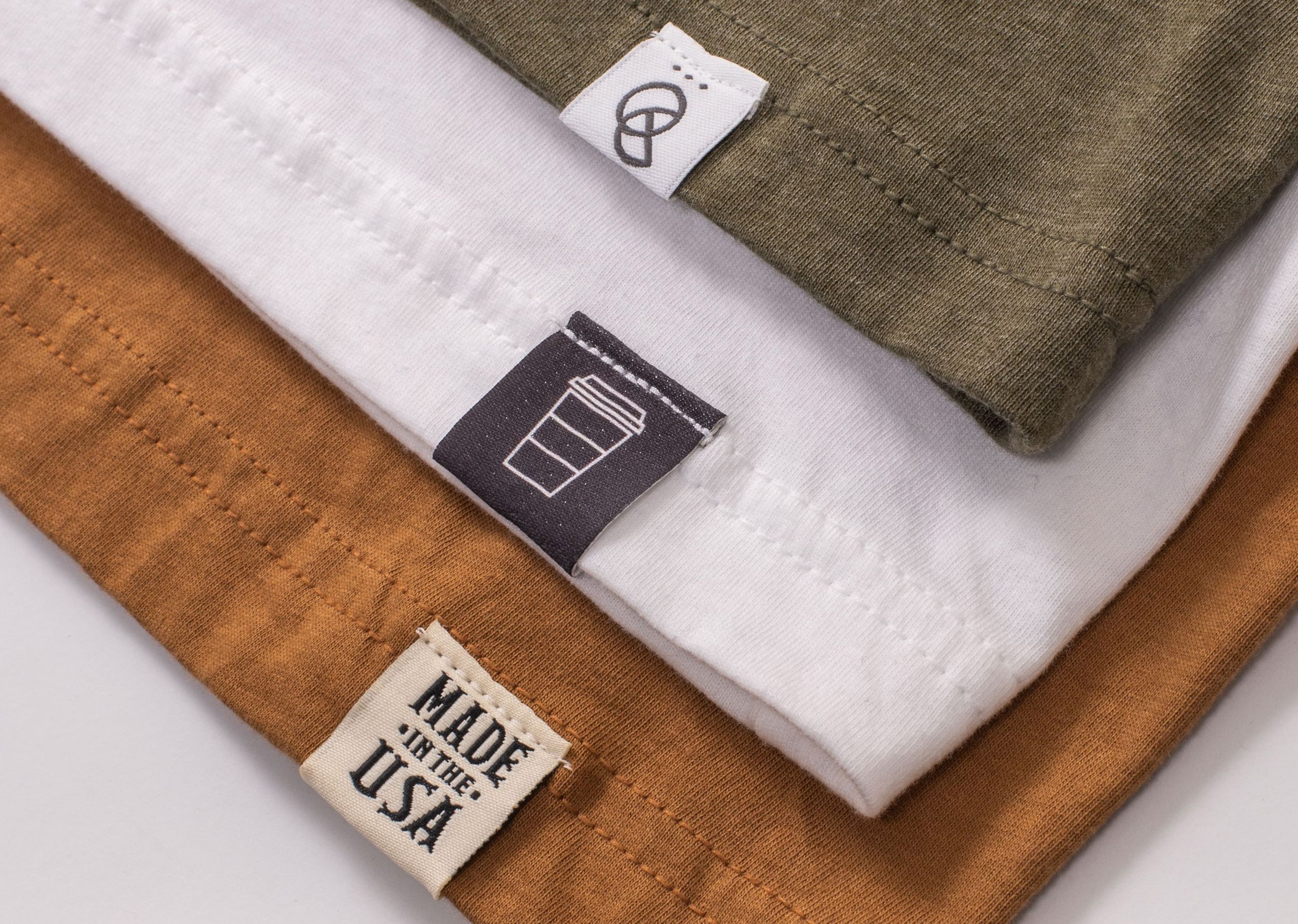 close up of three t-shirt with hem tags