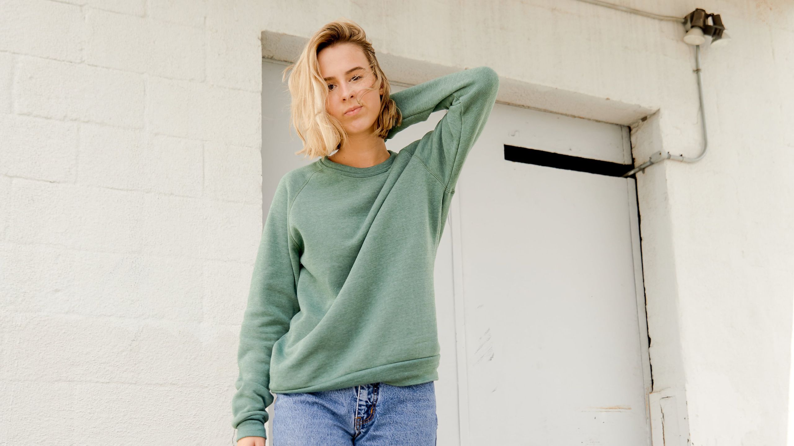 woman wearing a green sweatshirt