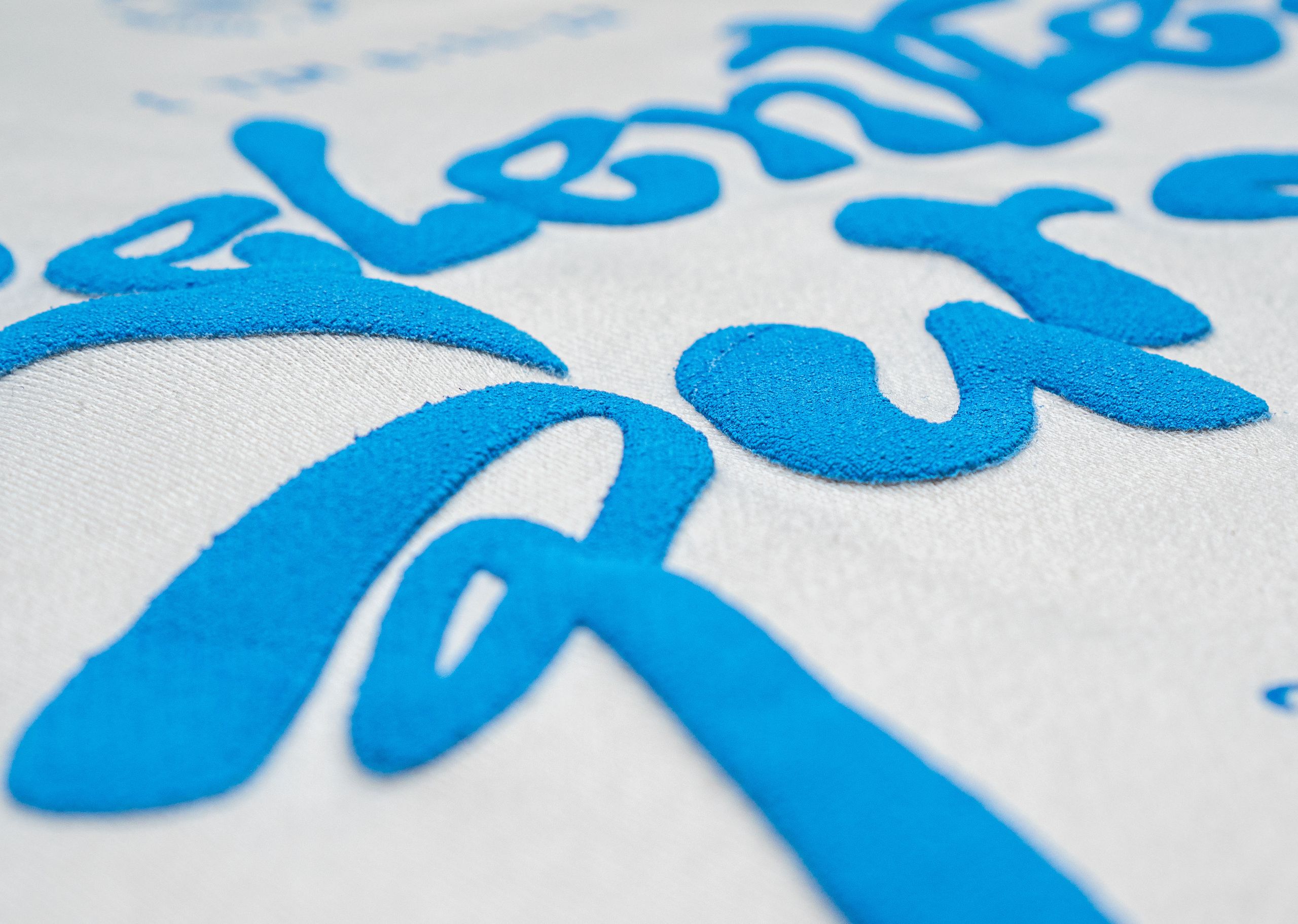 close-up on blue puff print on a white fleece