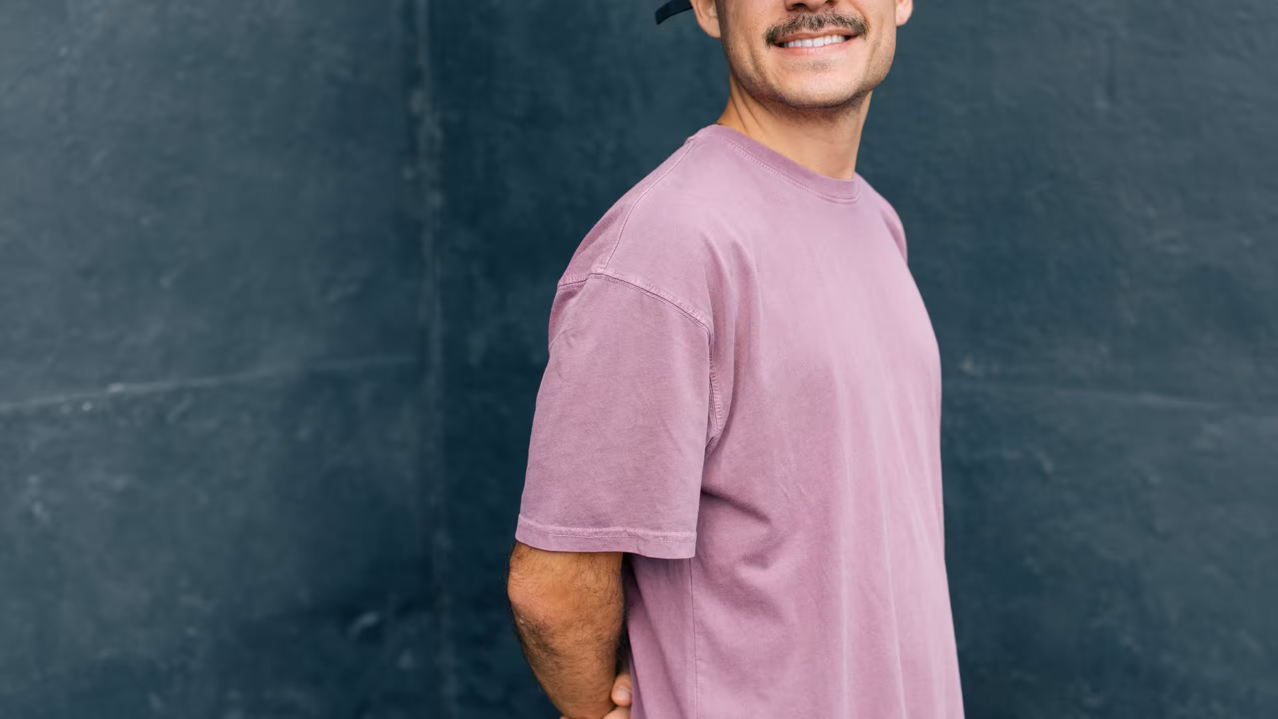 man wearing a desaturated pink shirt
