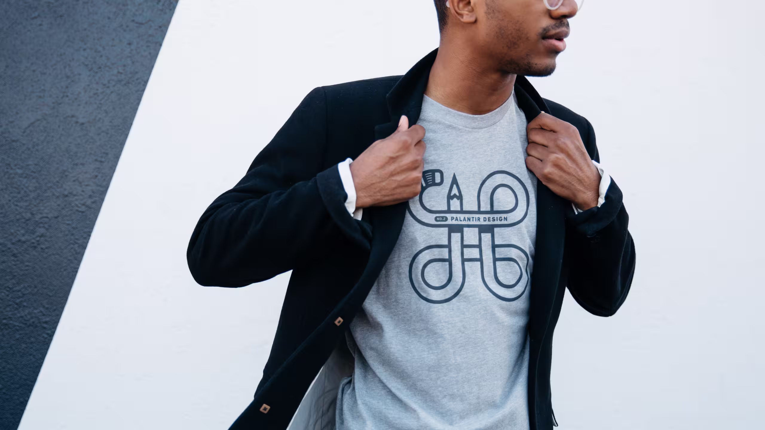 man wearing a black jacket over a grey t-shirt