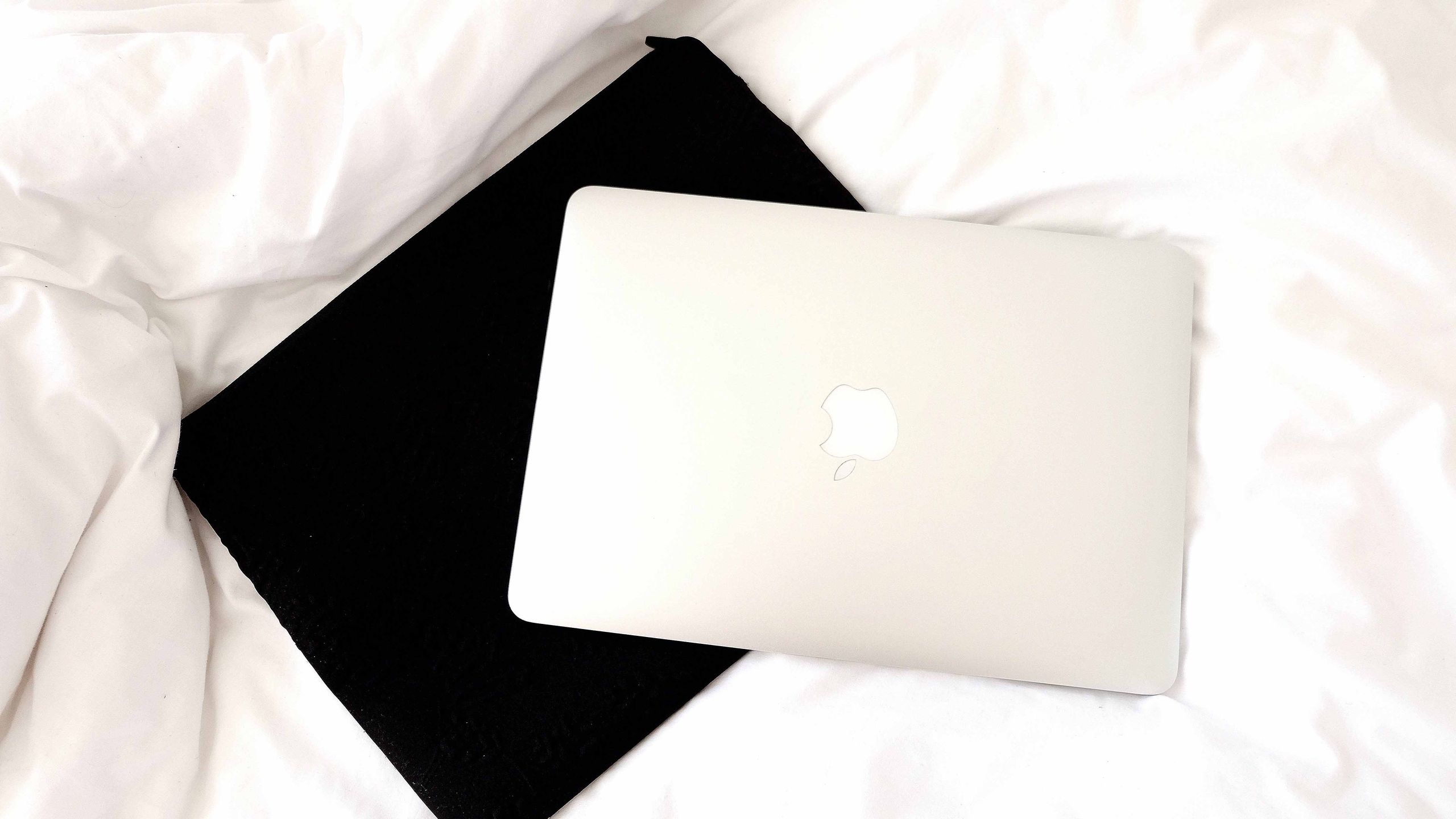 laptop sitting on top of a laptop sleeve