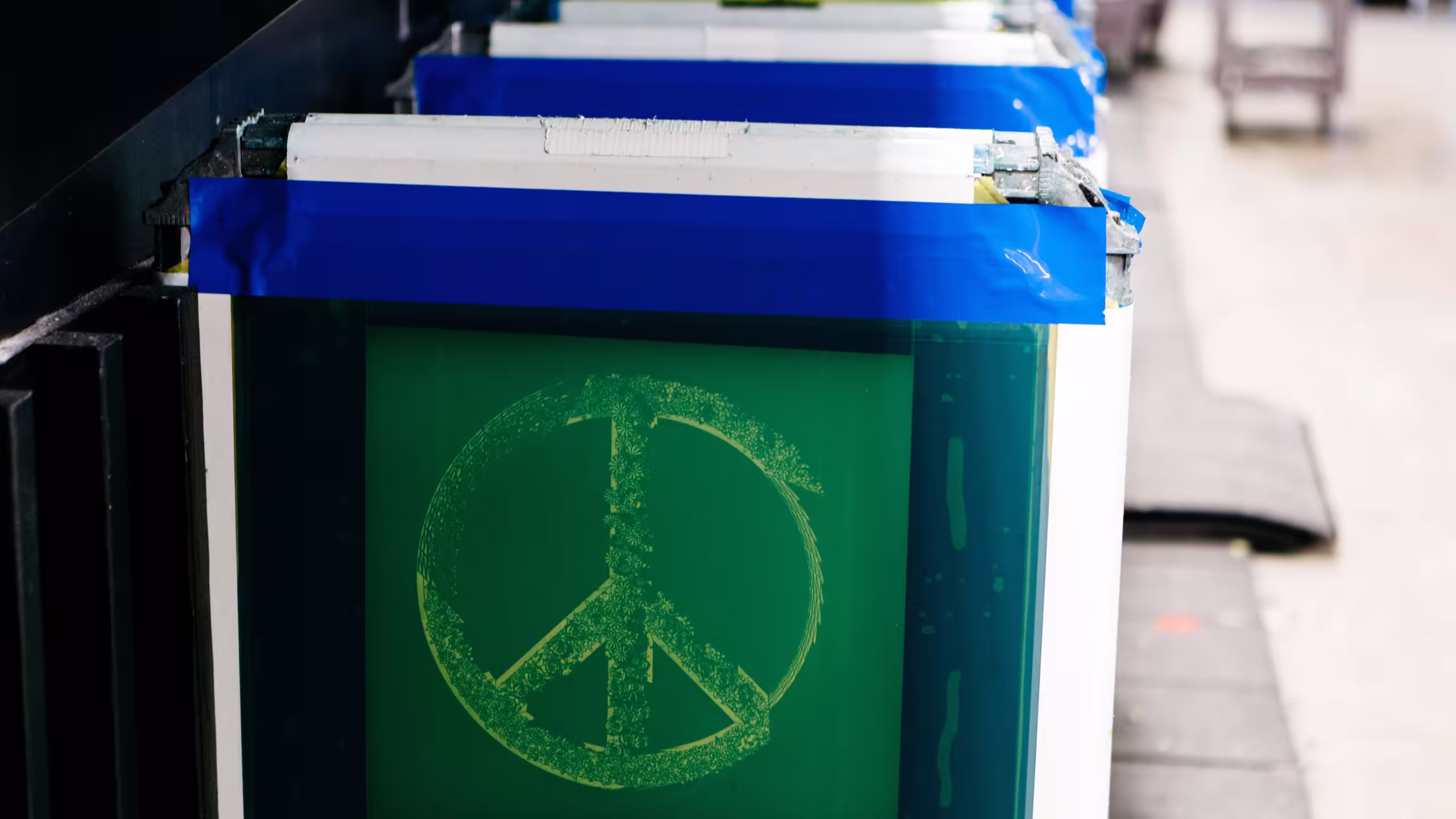 screen printing screens with the peace sign burned in 