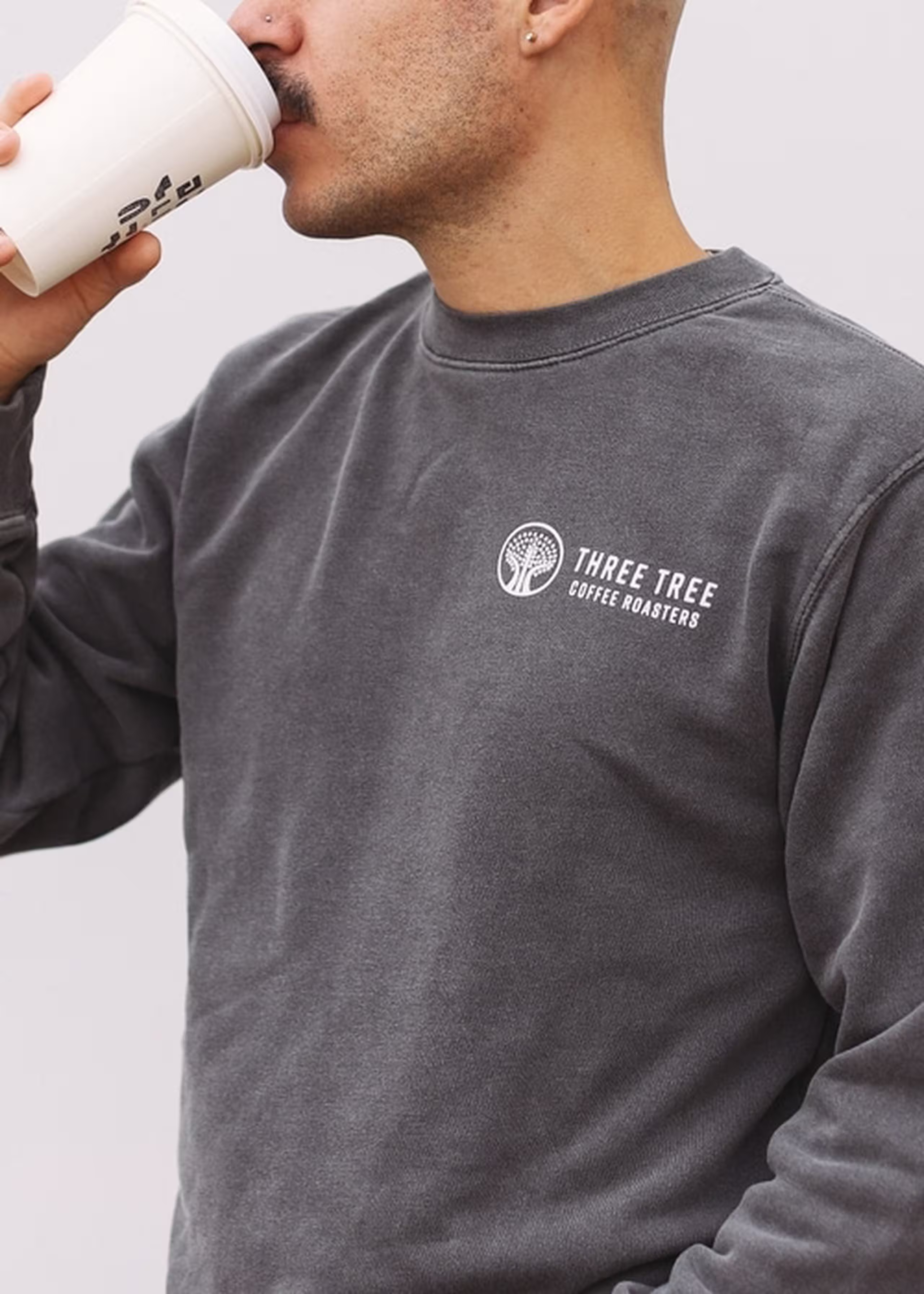 man wearing a gray crewneck sweatshirt