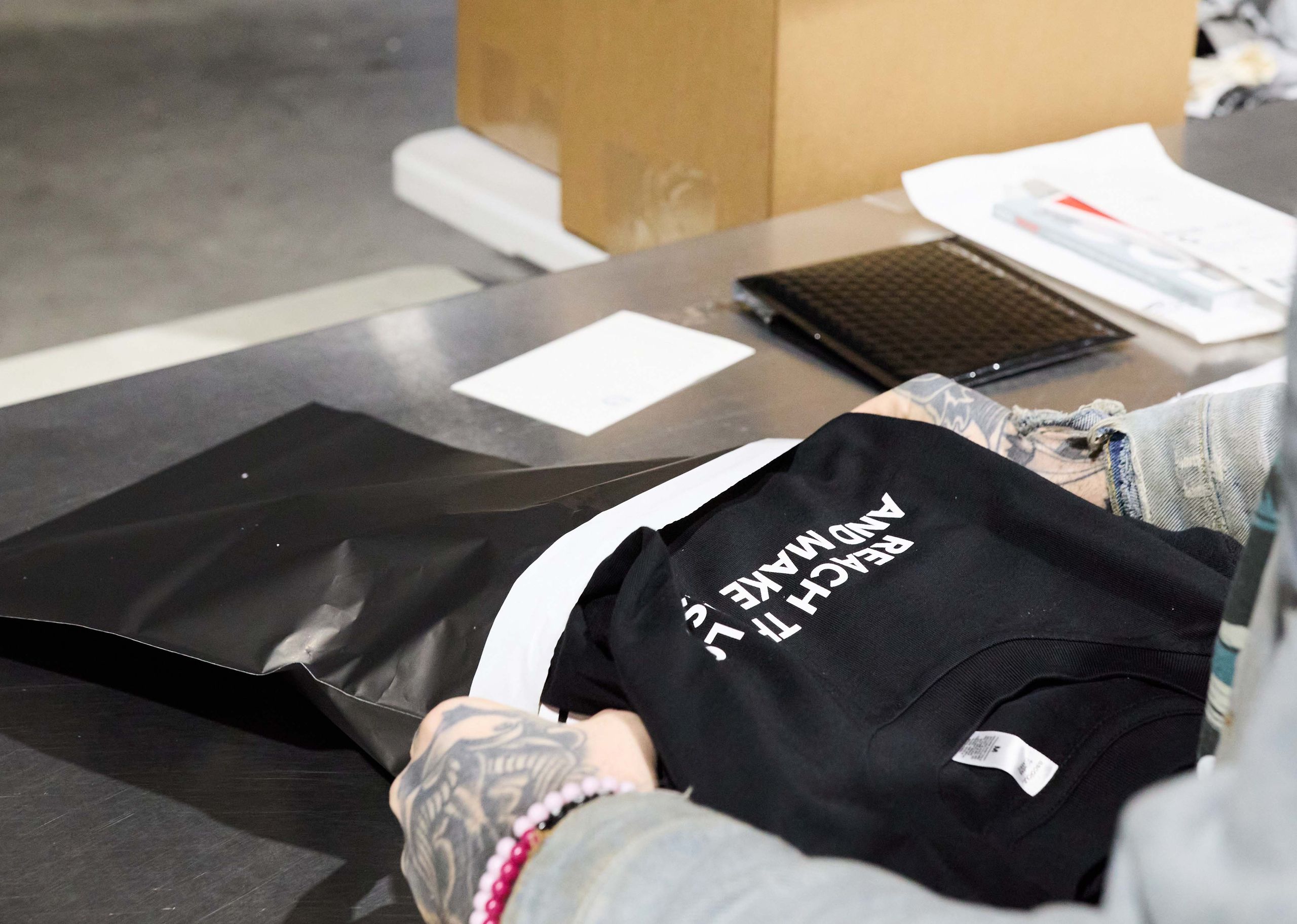 someone bagging a shirt to ship