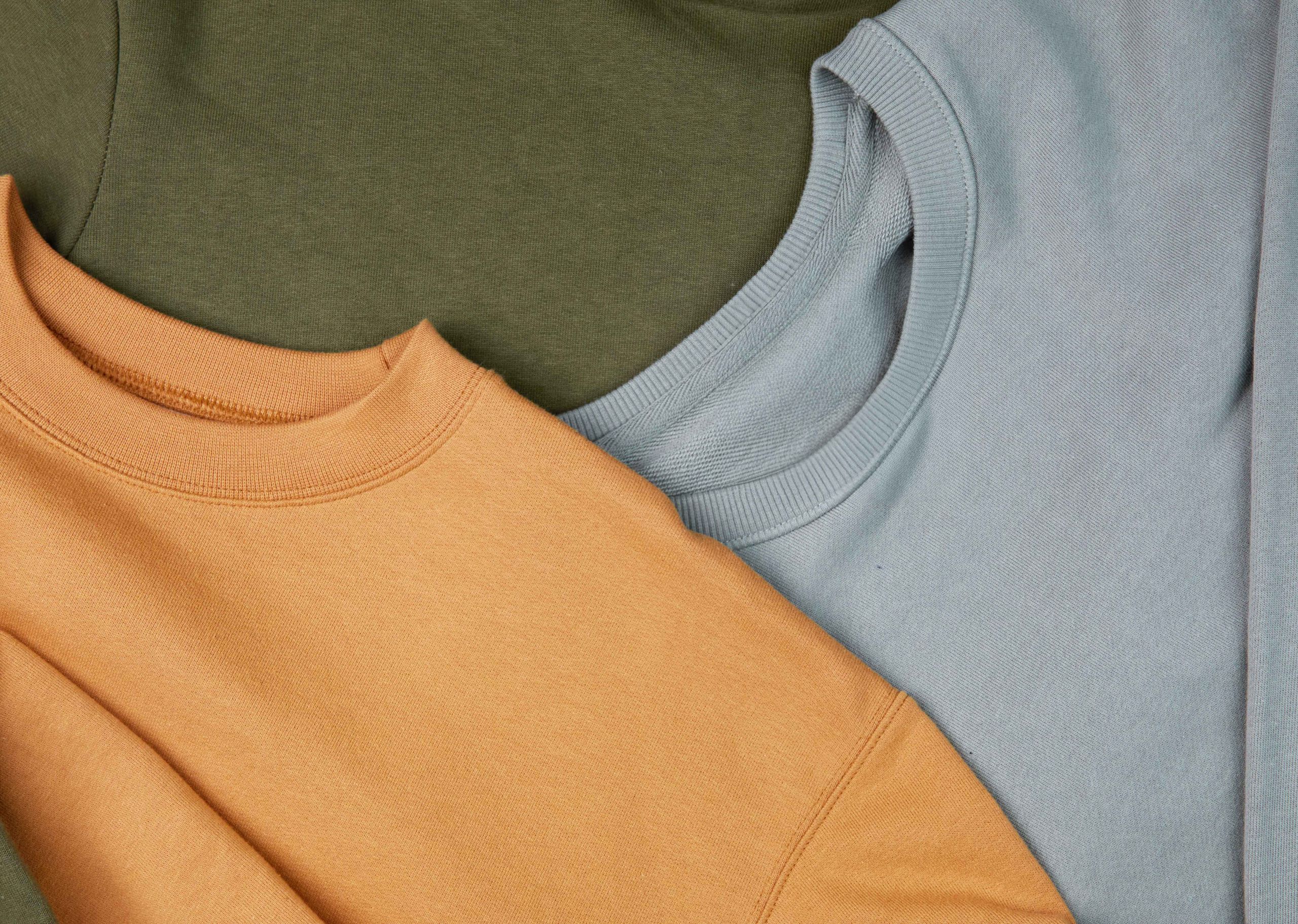 close-up of green, gold, and light blue sweatshirt
