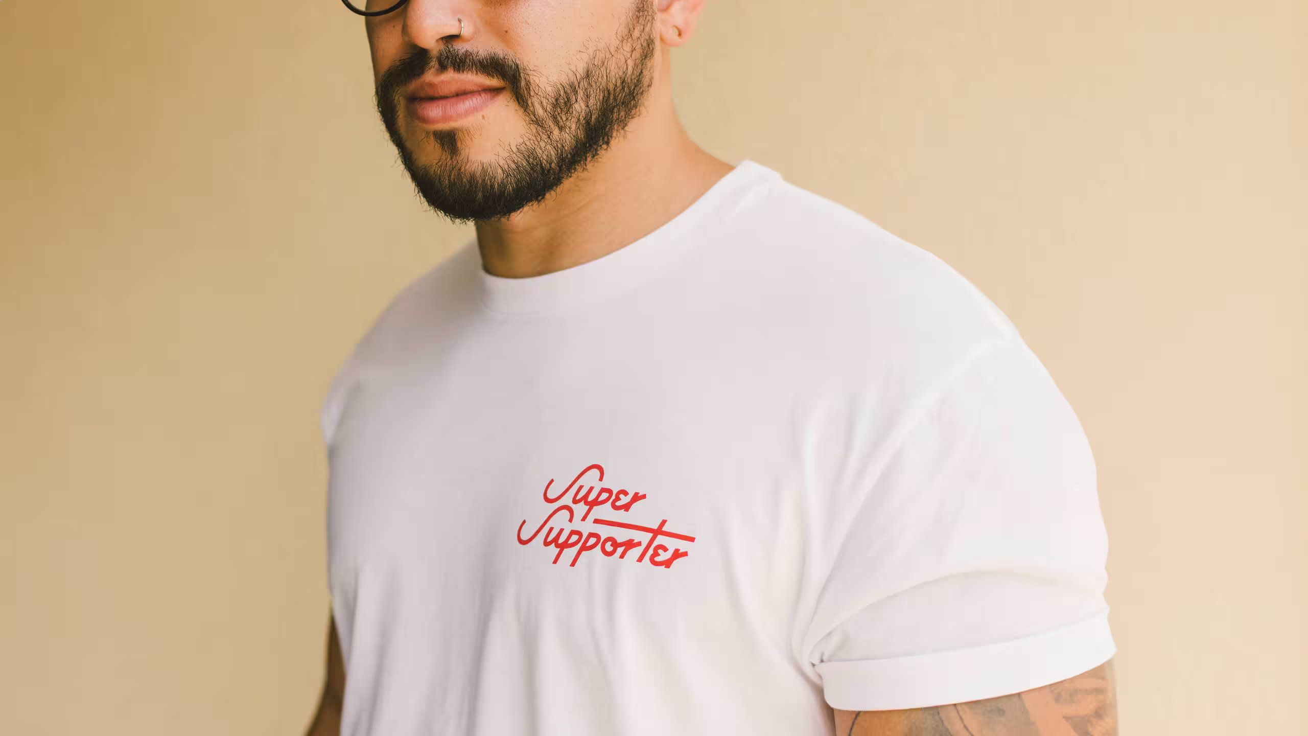 close up of a man wearing a white shirt with red text