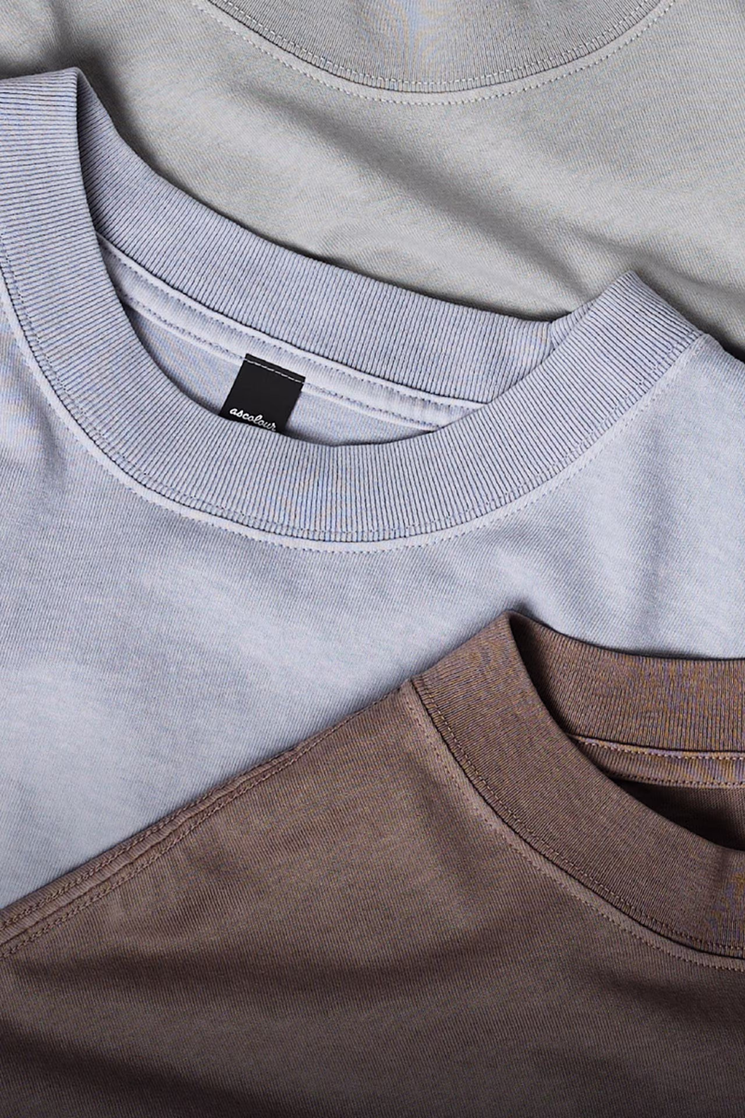 three t-shirts laying flat