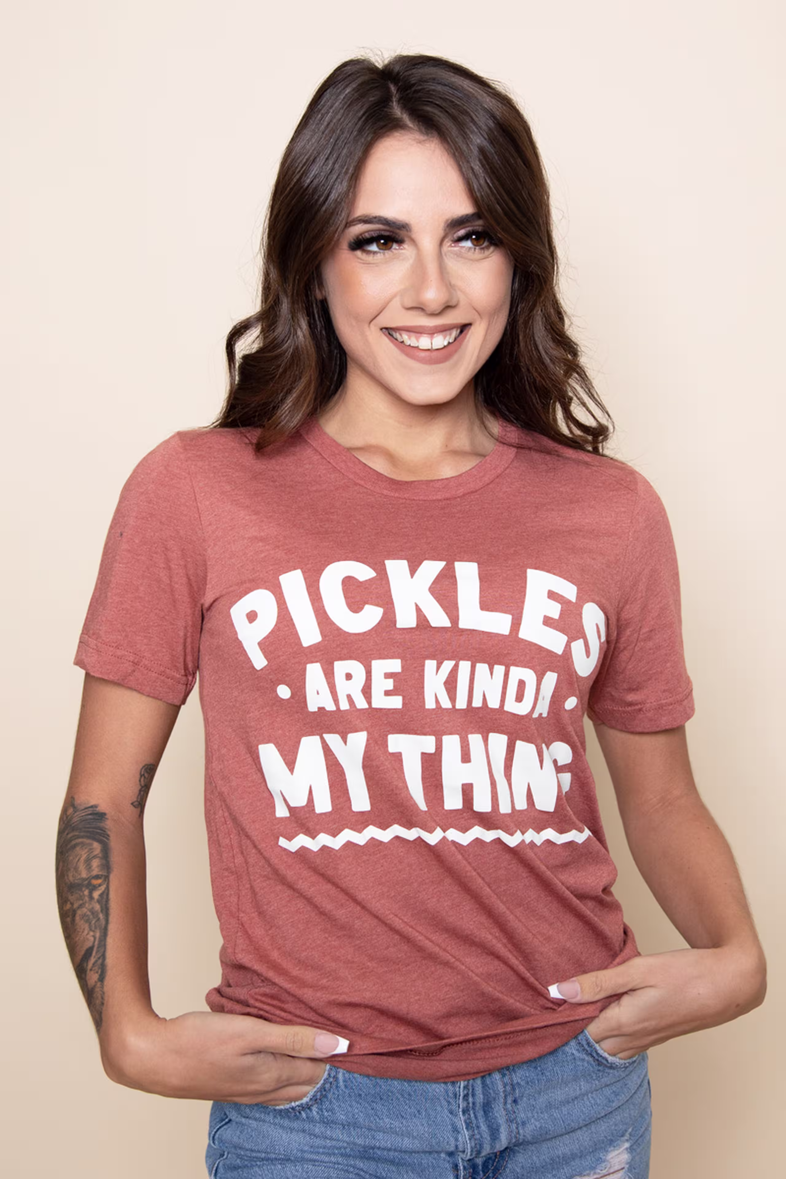 women wearing a dusty pink t-shirt with white words, pickles are kind of my think, printed on the front