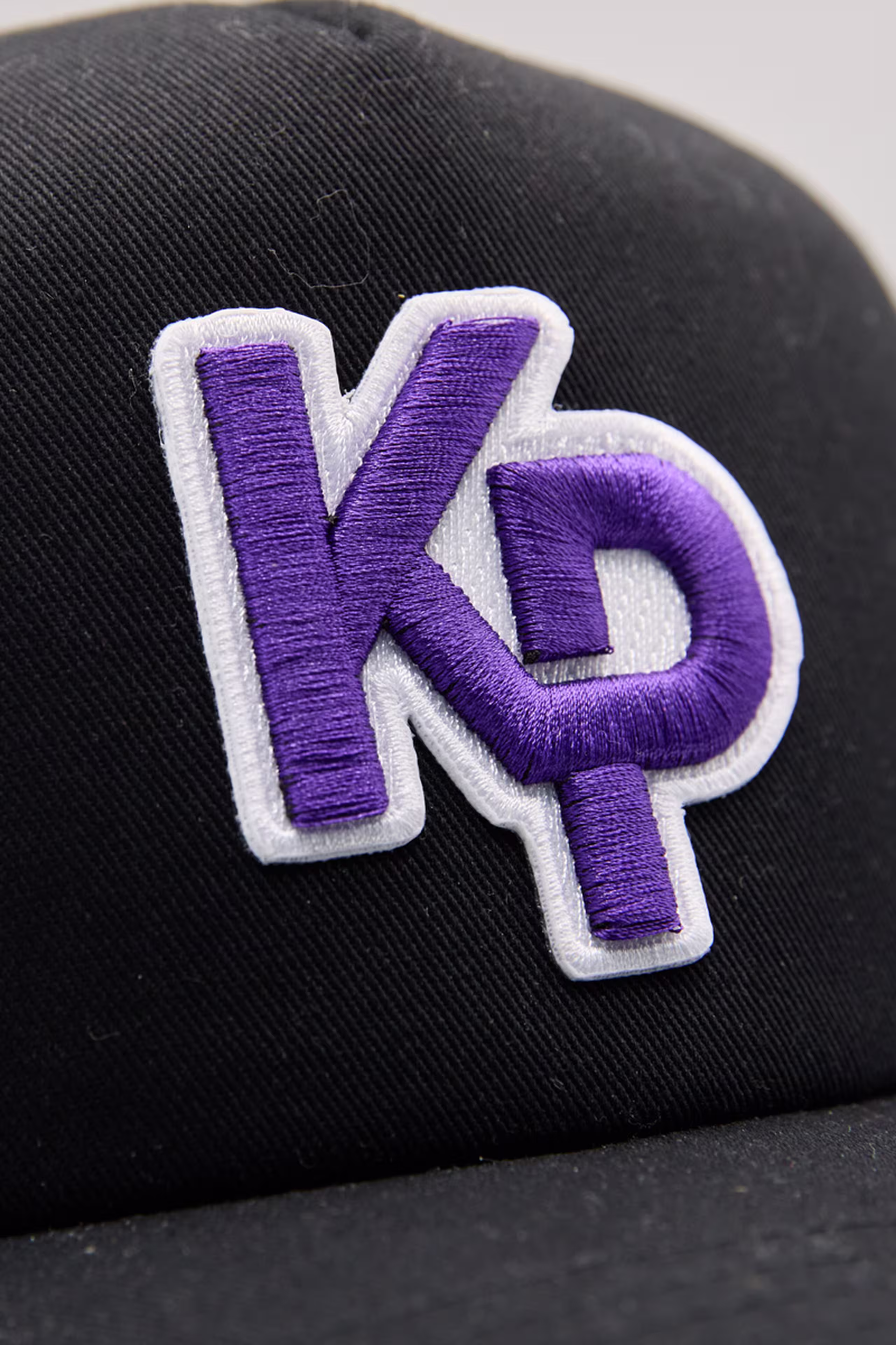 Close-up of k p monogram 3d embroidery