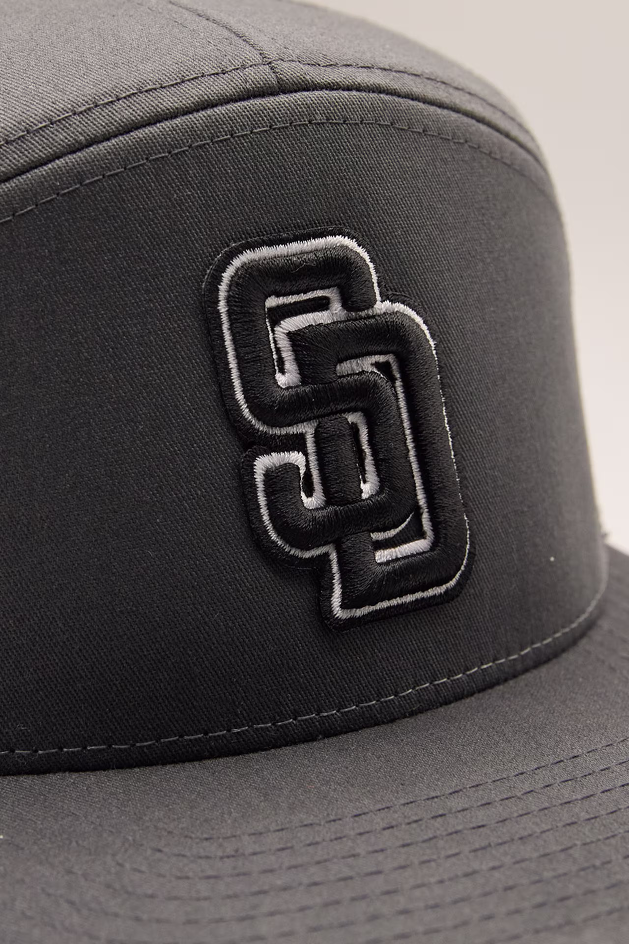 close up of a black s and d mongram 3d embroidered patch