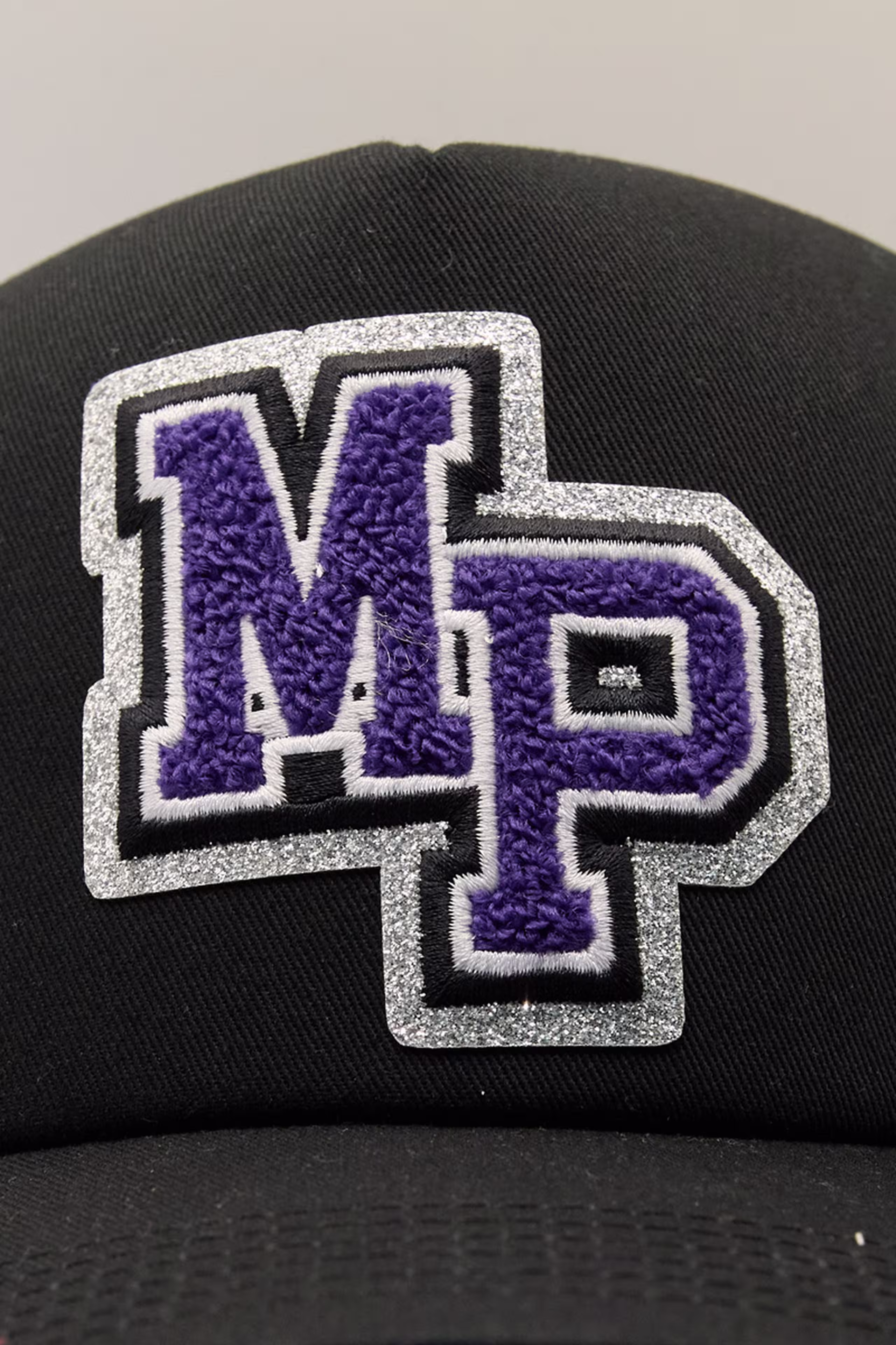 a purple and silver glitter chenille patch of a M and P