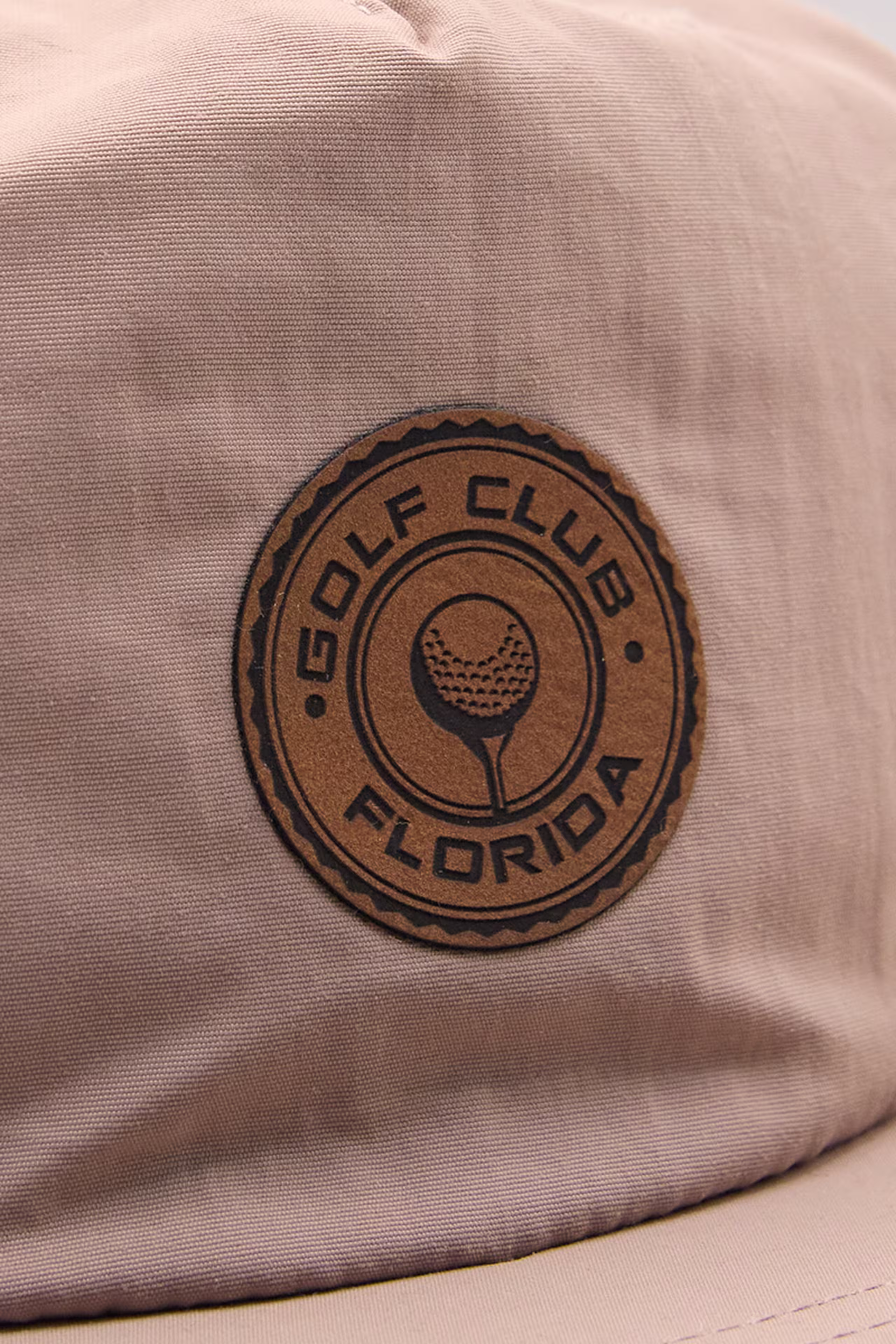 circle faux leather patch on a dusty pink hat