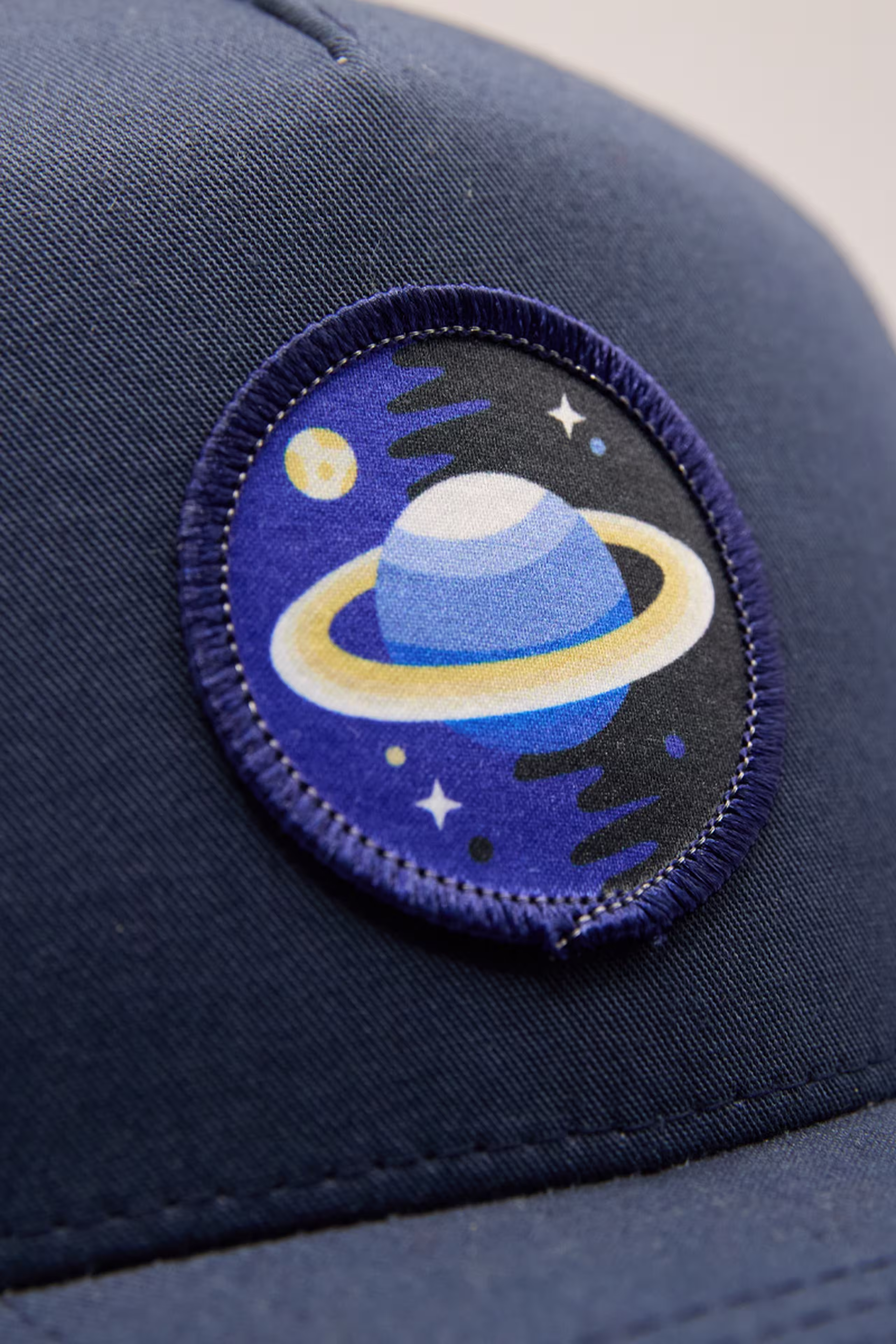 close-up of an illustration of planet with rings sublimated patch
