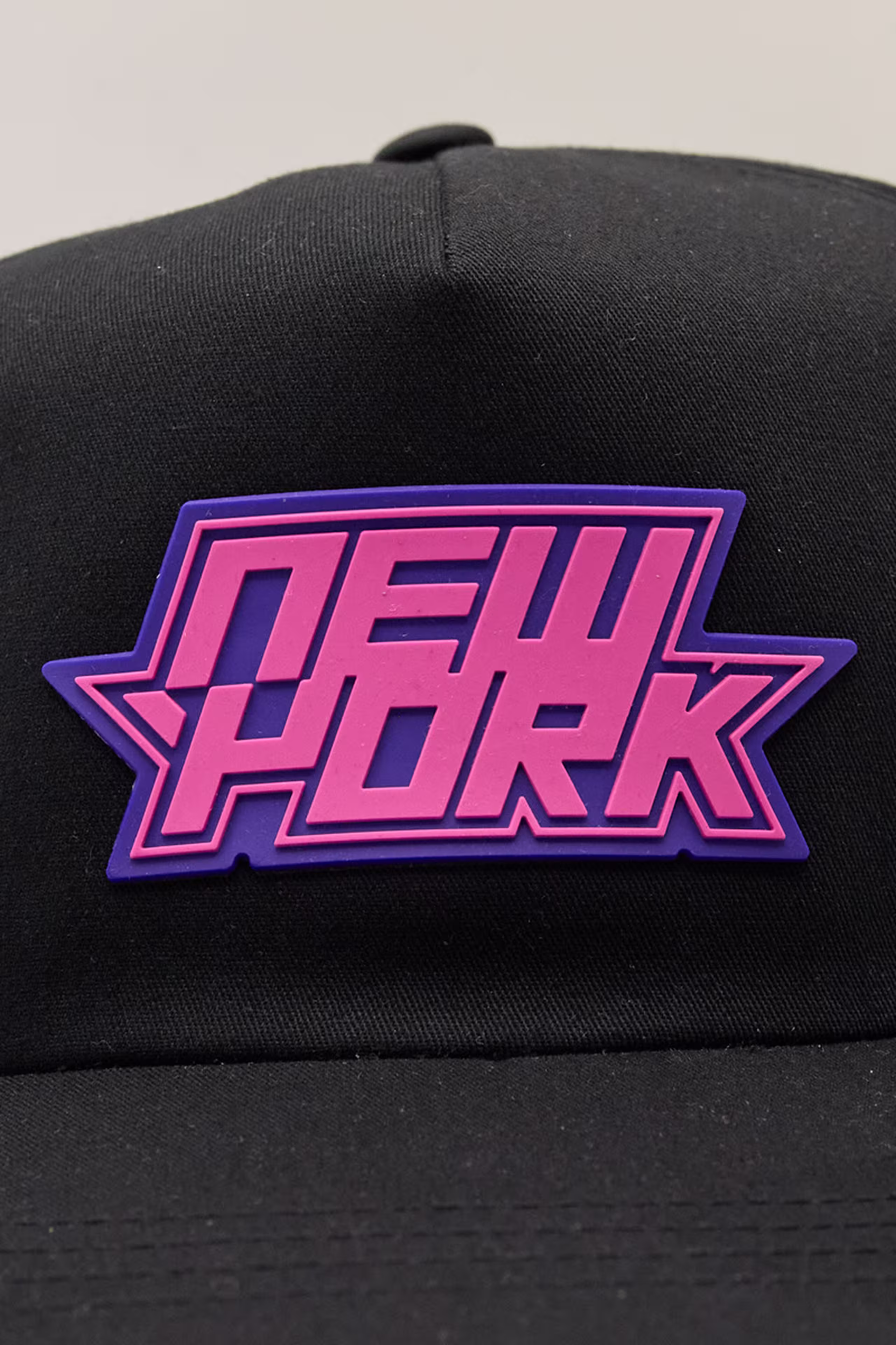 a pink and purple New York word as a molded patch