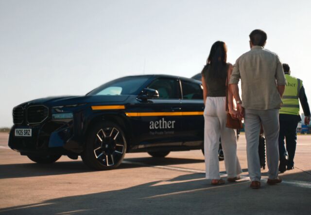 couple waiting by their BMW transfer