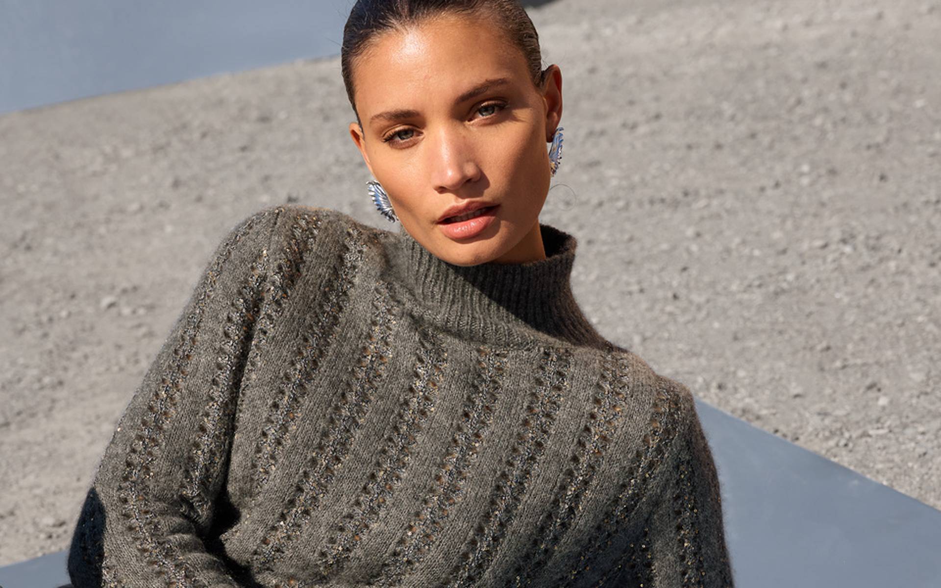 Grey knit sweater with a stand-up collar, openwork and textured knit in a vertical pattern, and a straight fit.