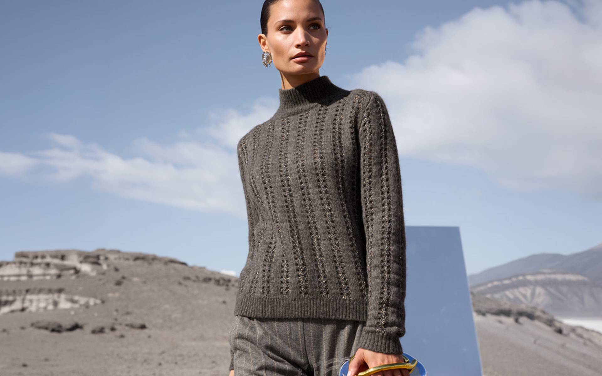 Openwork and textured knit on a grey sweater with a stand-up collar, long sleeves and a straight fit.