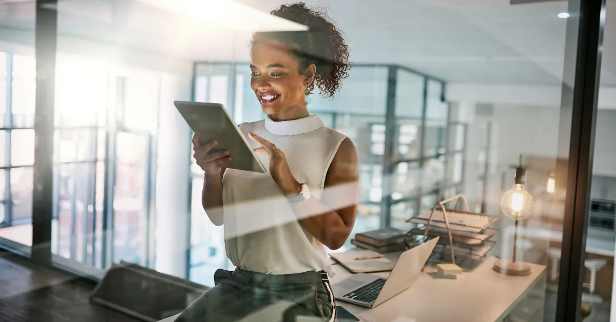 Woman looking at Ipad who works in AI tech