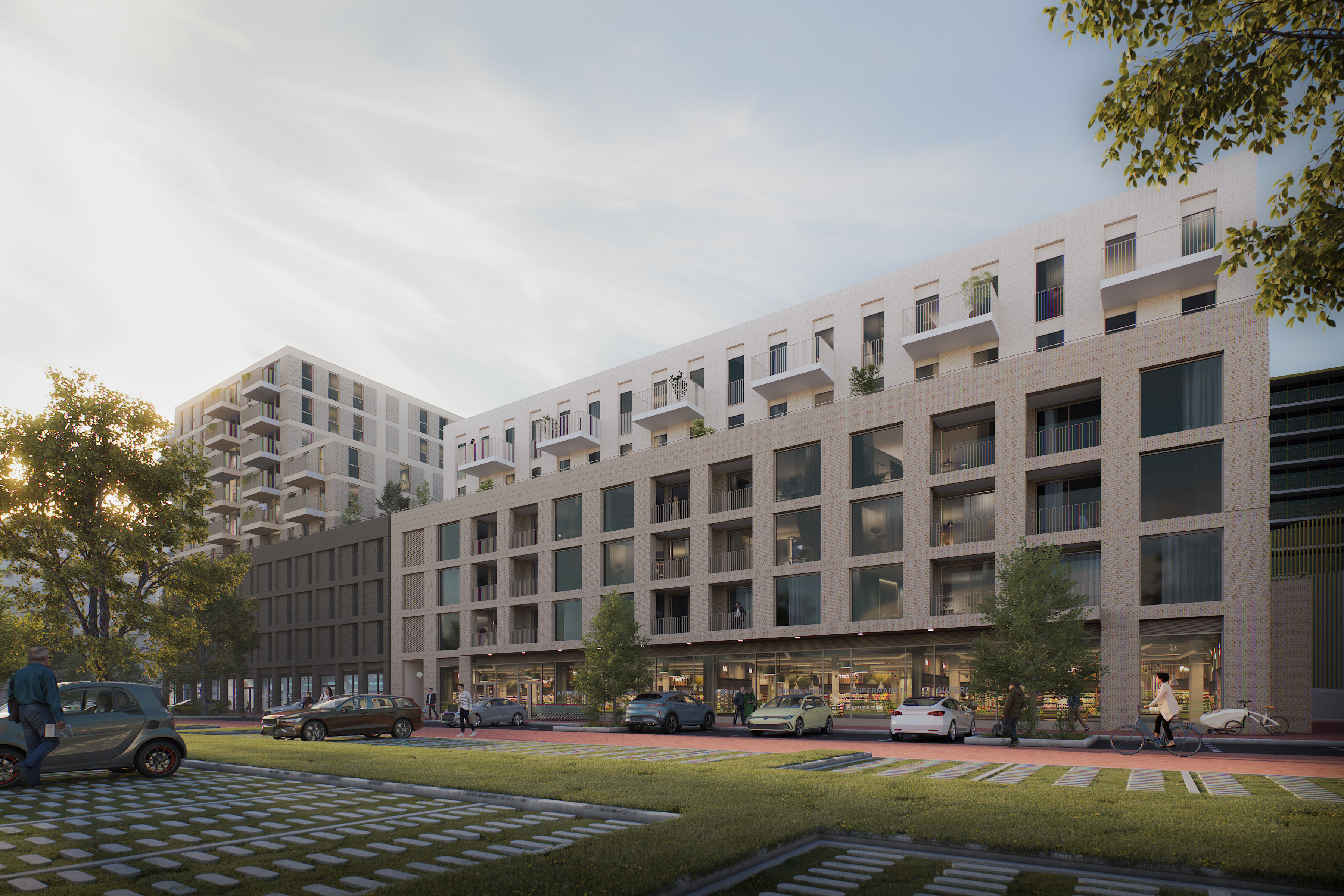 Modern mixed-use apartment building with ground-floor shops, balconies, parked cars, trees and people walking and cycling in soft evening light.