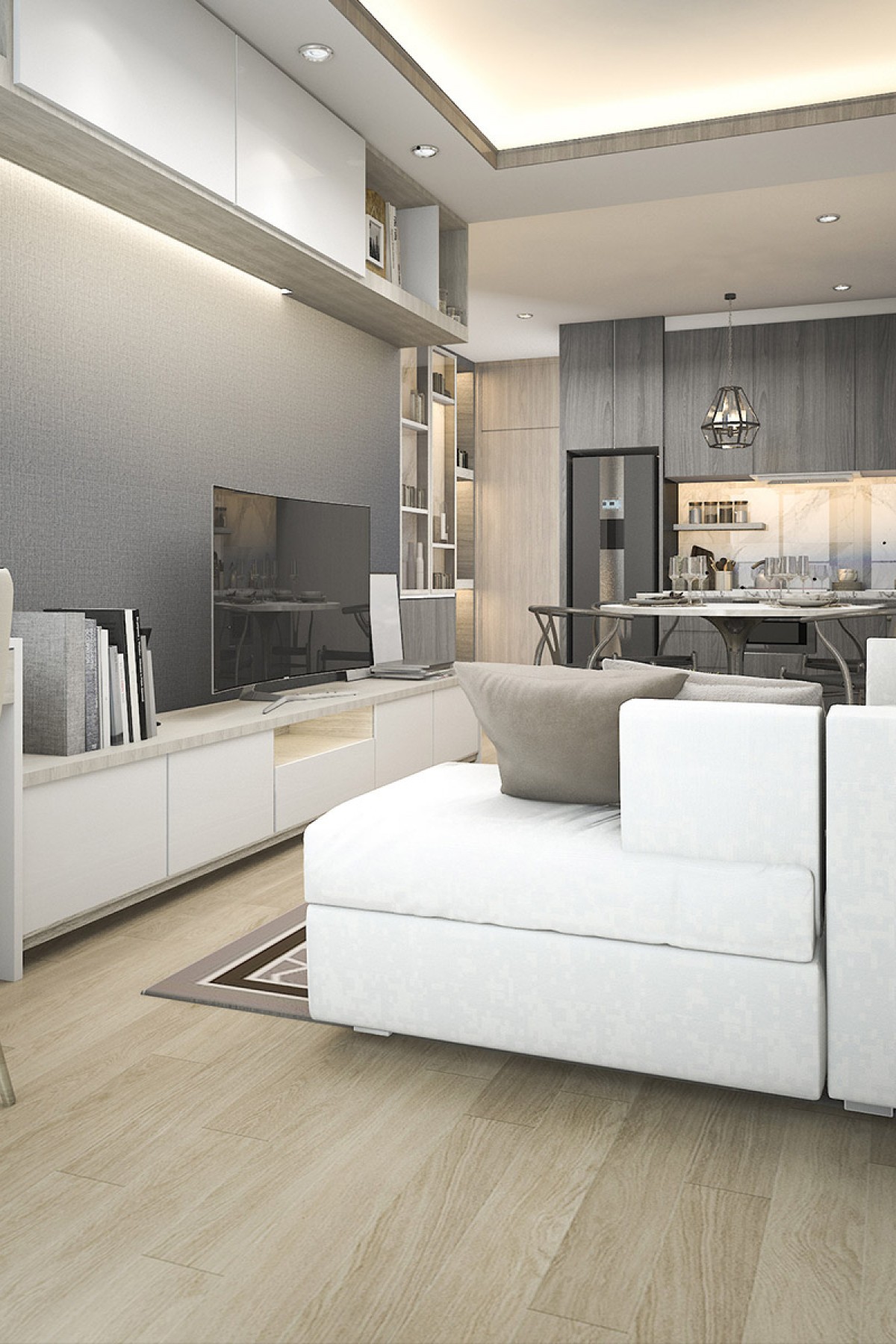 Modern living room with white couch, flat screen TV, and dining table with chairs in the background.