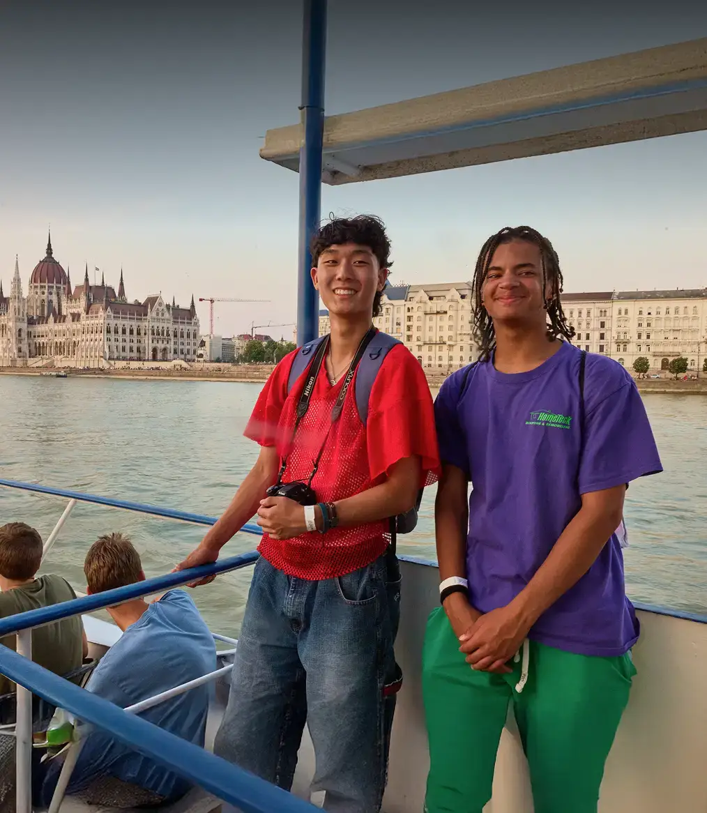 students on tour riding a boat in budapest
