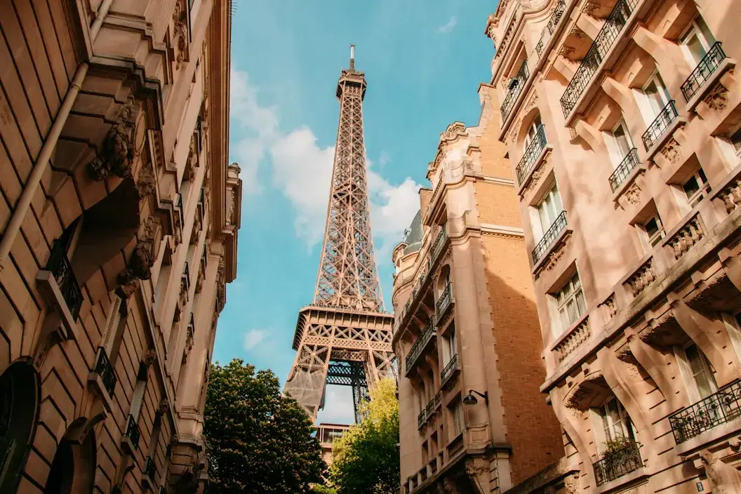view of the eiffel tower between buildings in paris