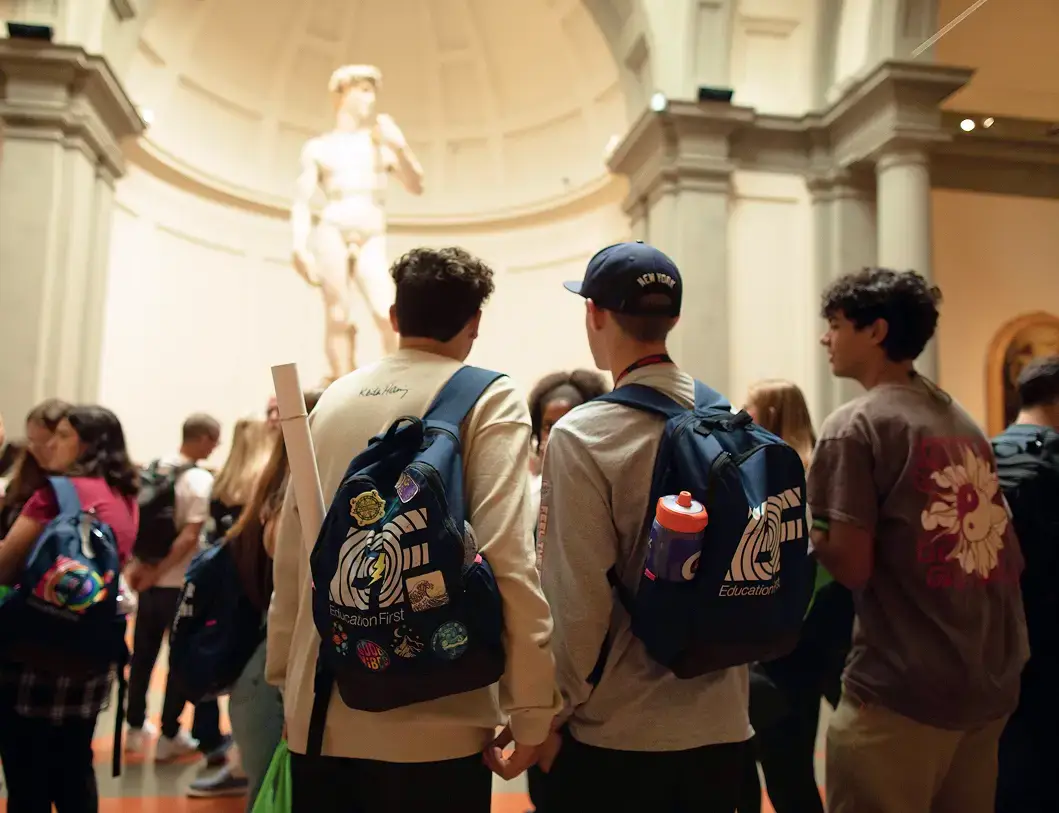 Two travelers admiring Michelangelo’s David at the Galleria dell’Accademia in Florence, Italy