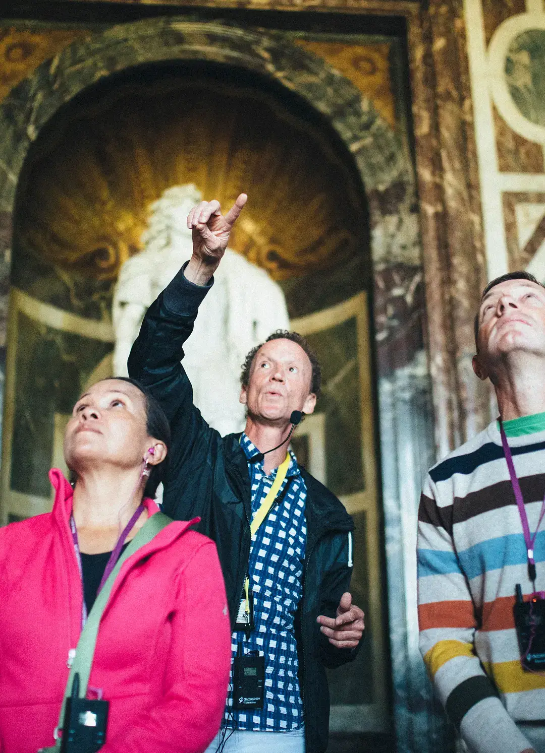 Tour director pointing and speaking with adult tour group